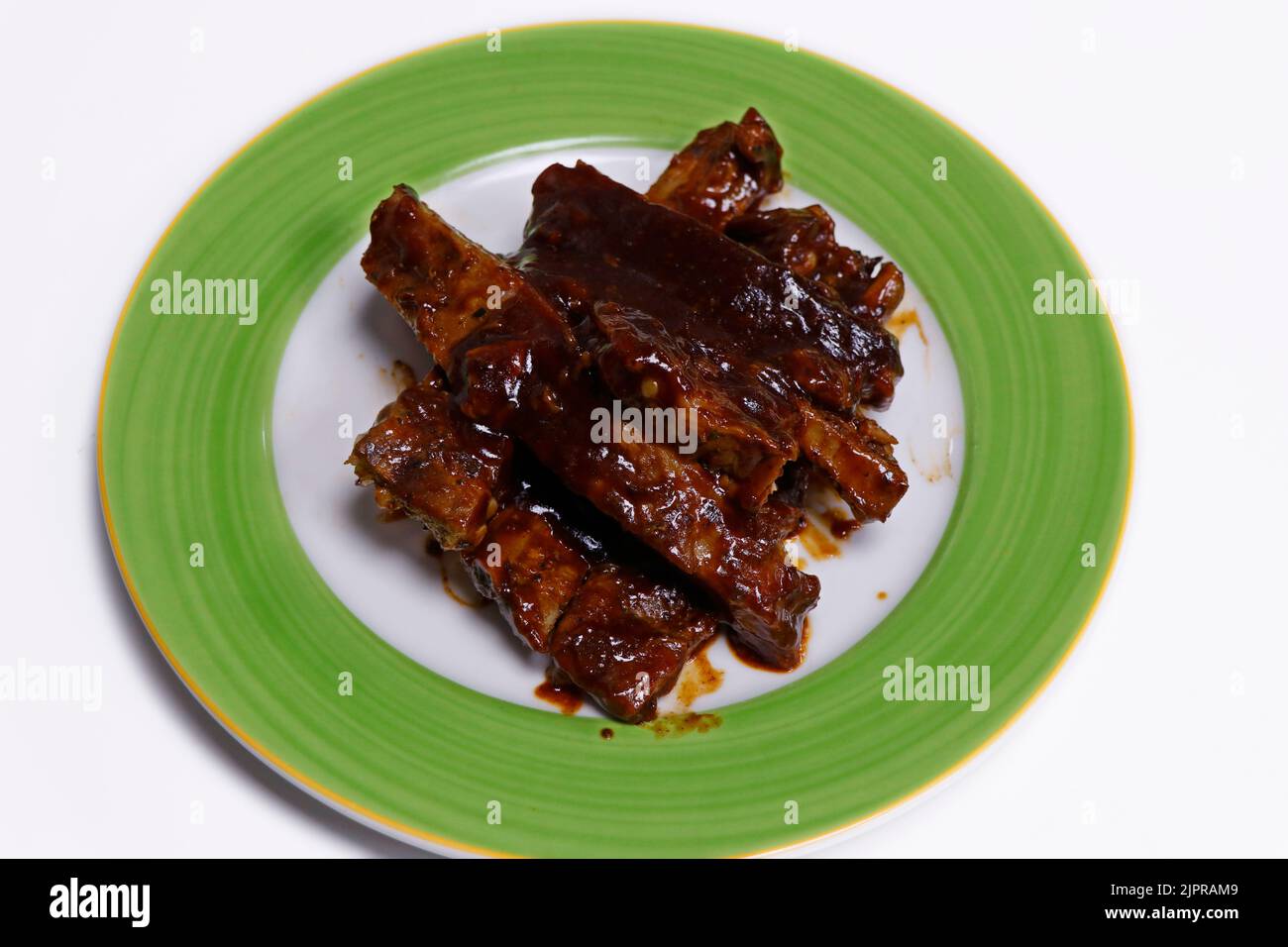 barbeque sauce glazed char grilled pork spare ribs in a plate Stock