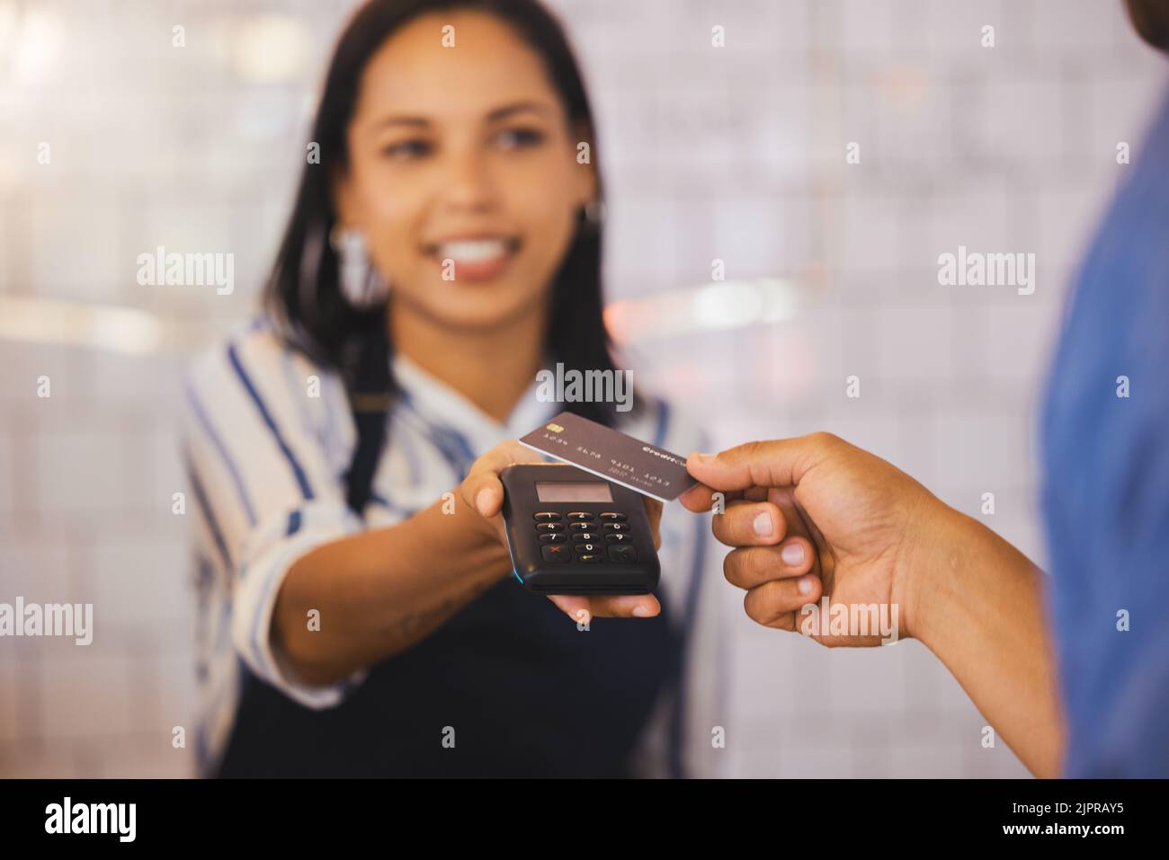 Credit card, payment and customer with an electronic reader in the hand of a cashier to process a fintech purchase or money spend. Consumer making a Stock Photo