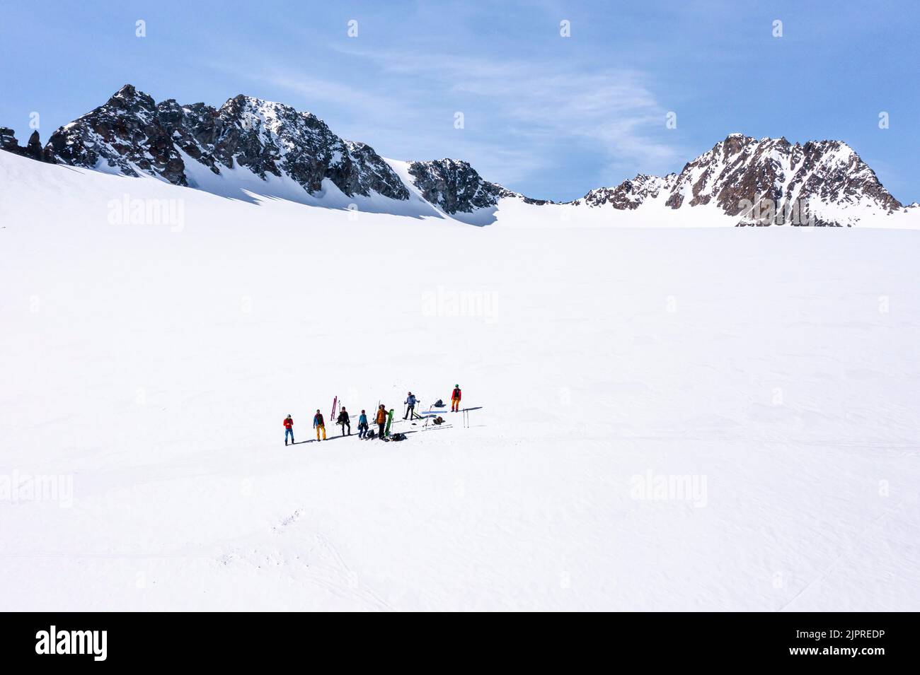 Aerial view of a group of alpinists in the high mountains with the glacier Lisener Ferner, Brunnenkogel and Luesener Spitze in the background Stock Photo