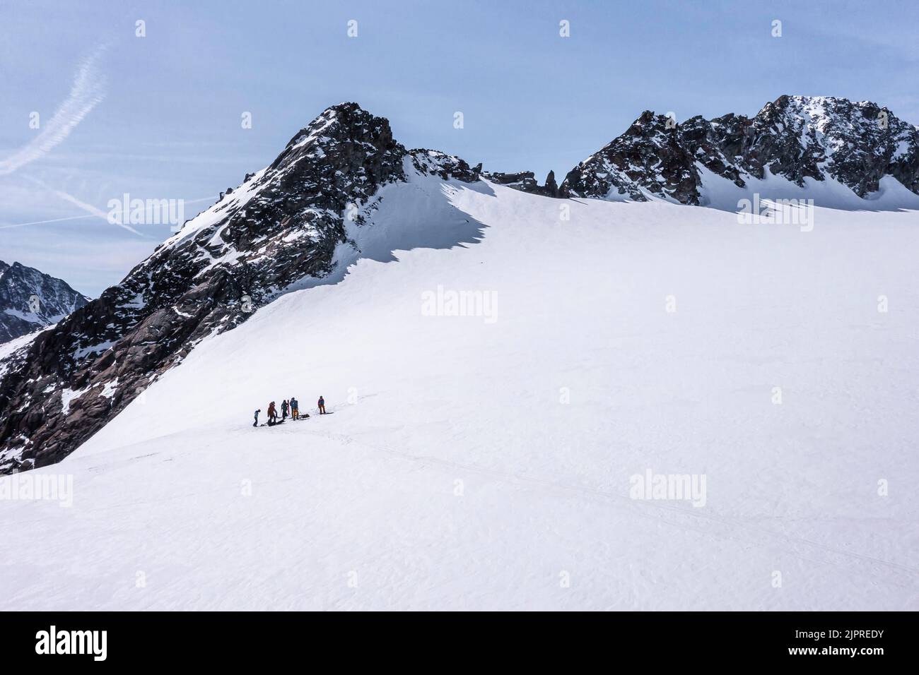 Aerial view of a group of alpinists in the high mountains with the glacier Lisener Ferner, Brunnenkogel in the background, mountains in winter Stock Photo