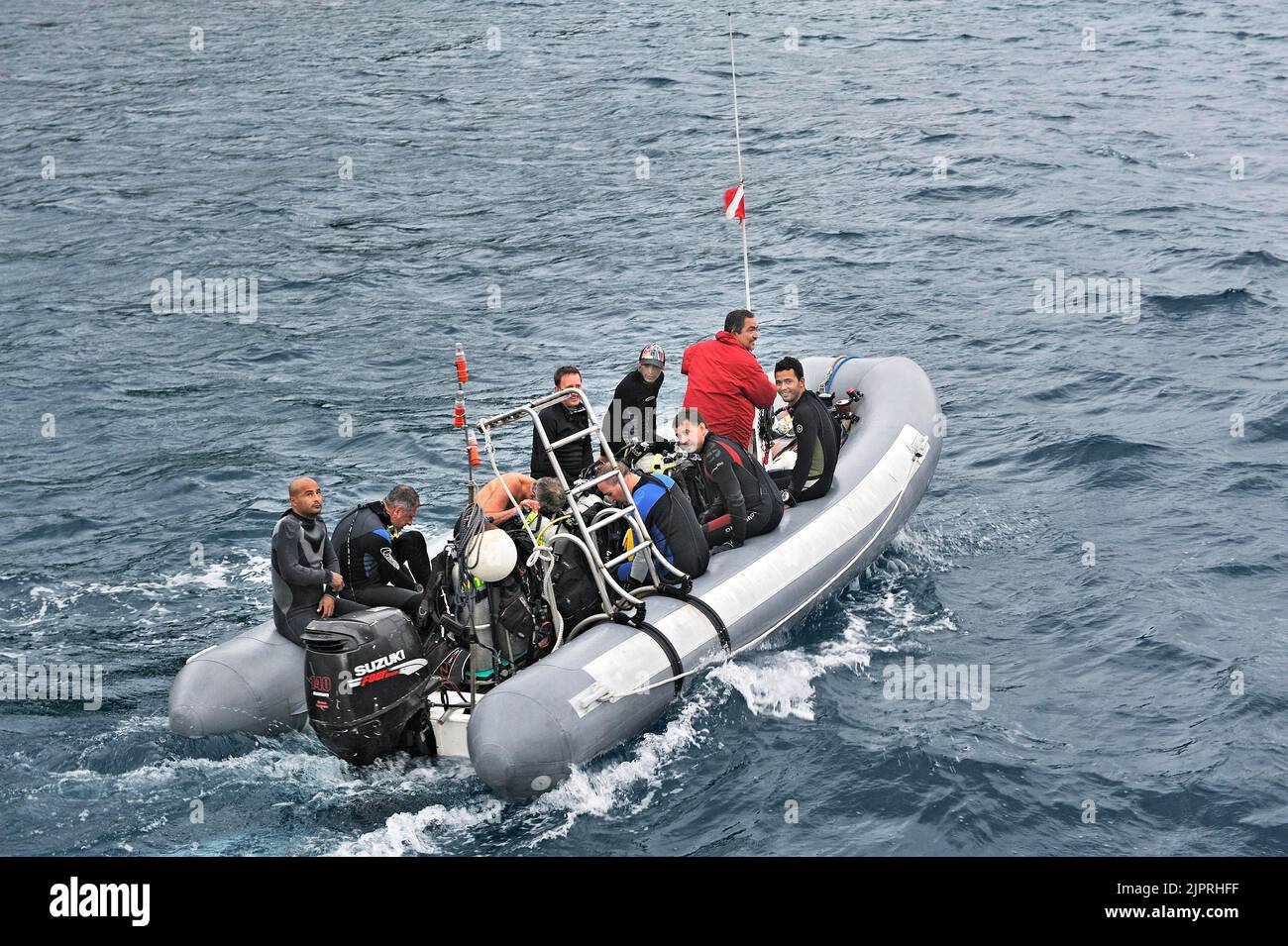 Divers travel to their dive site in an inflatable boat, Okeanoss ...