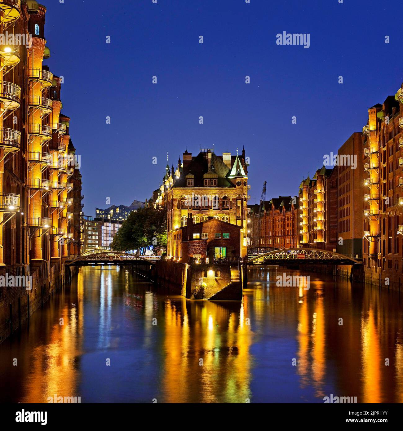 Illuminated moated castle in the Speicherstadt in the evening, Unesco ...