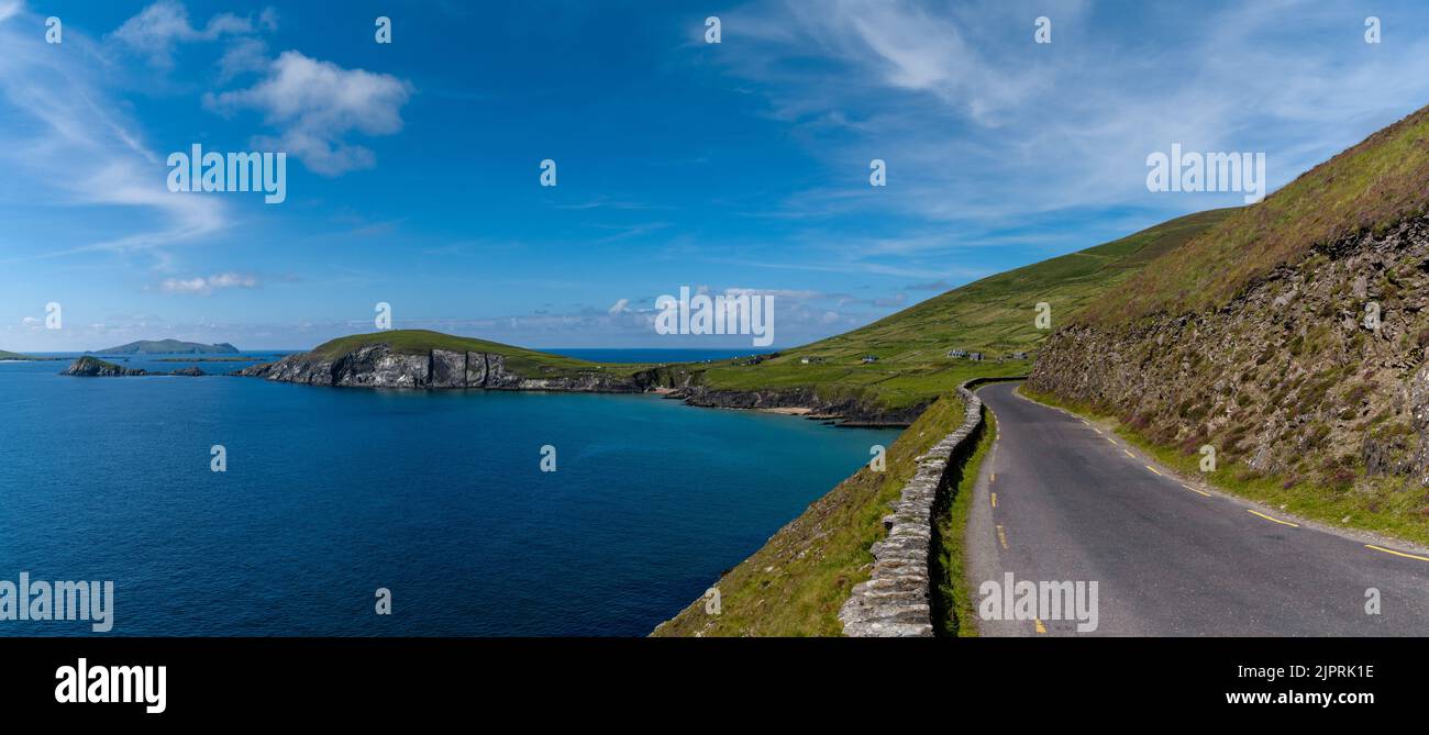 panorama landscape with Wild Atlantic Way coastal road leading to Slea Head on Dingle Peninsula in County Kerry of western Ireland Stock Photo