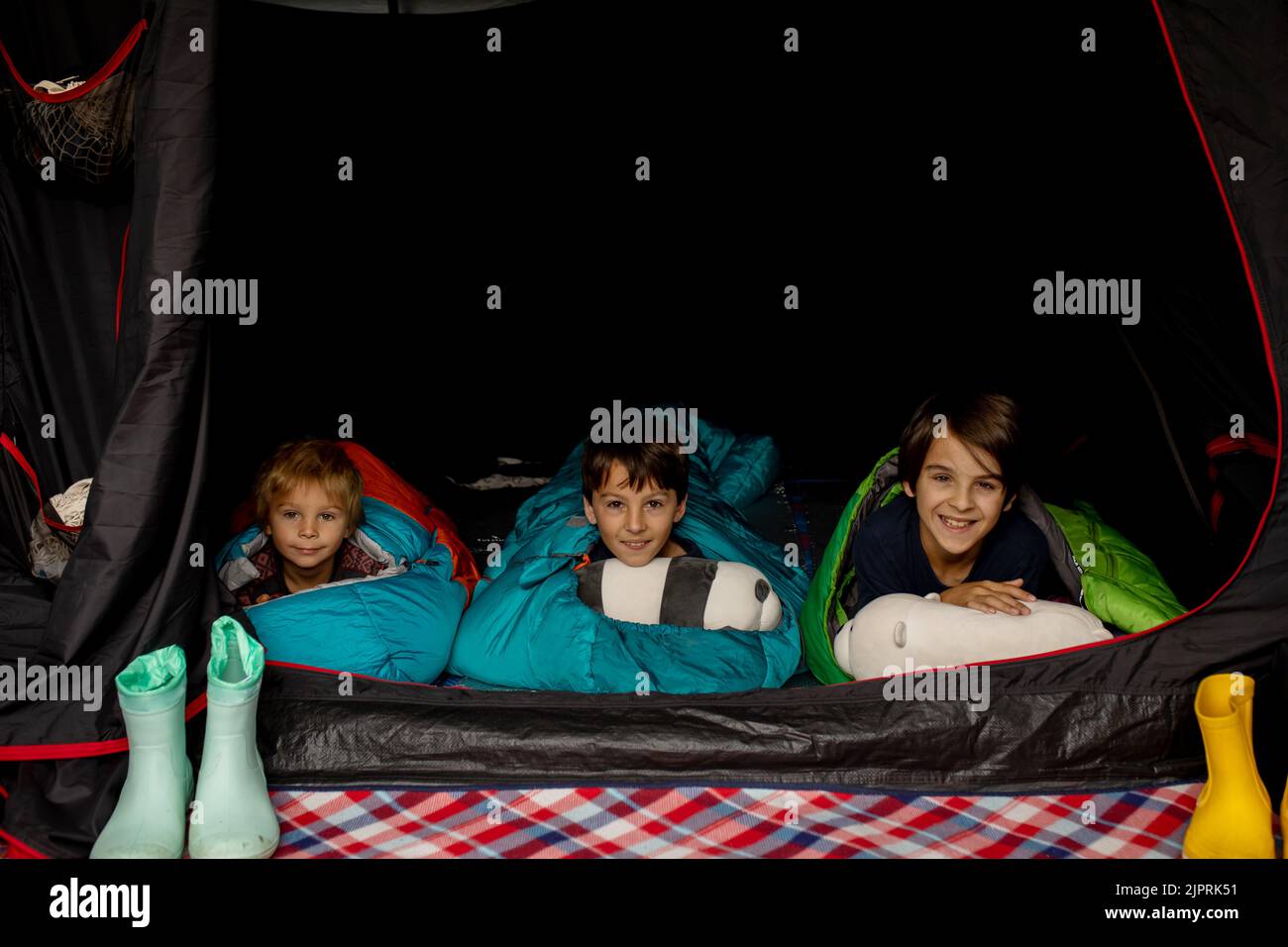 Children, sibilngs, sleeping in sleeping bags in a tent in Norway, wild