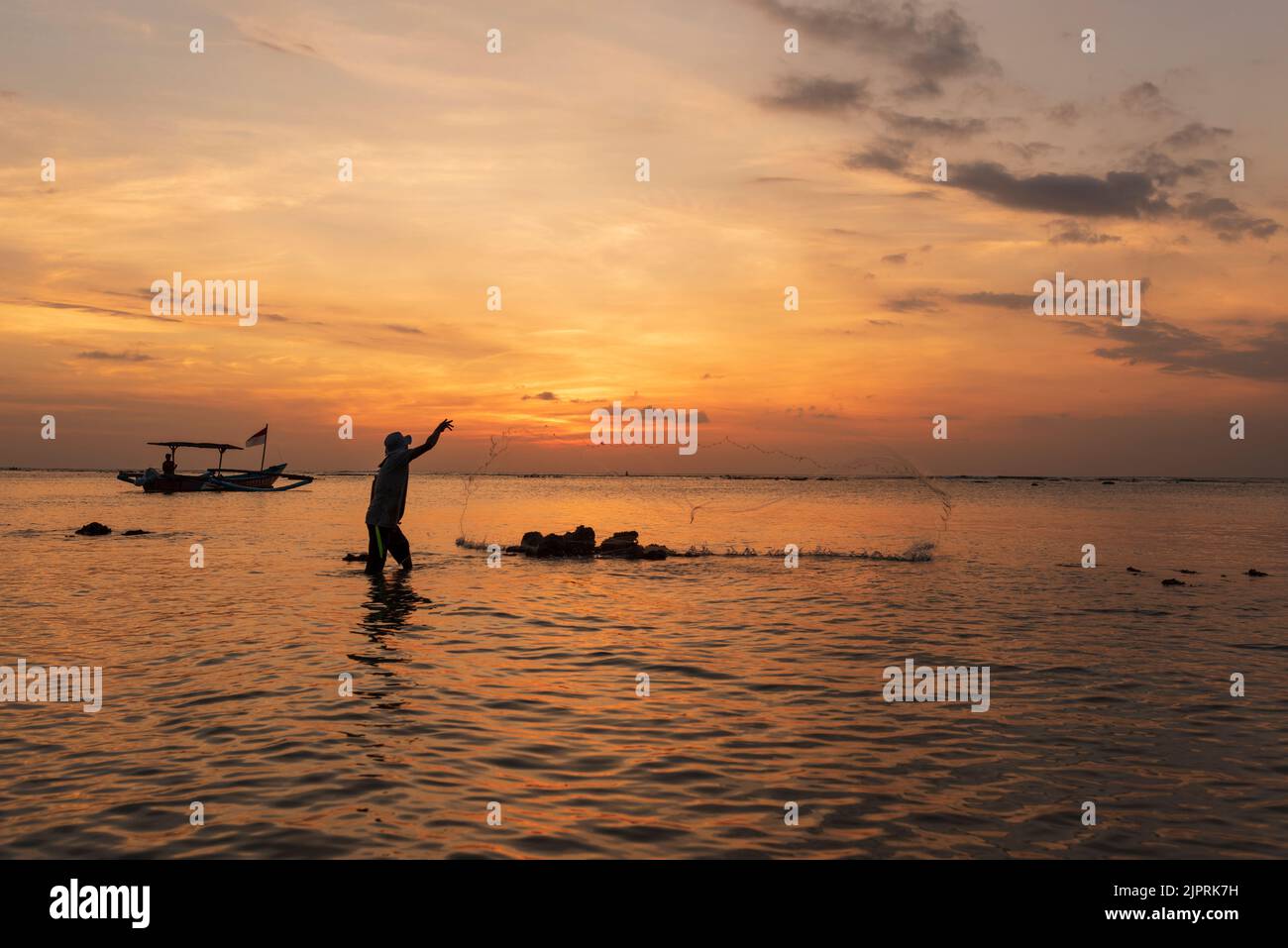 KUTA BEACH - BALI - INDONESIA . MAY 14, 2017. Fisherman fishing in the evening on Kuta beach Stock Photo