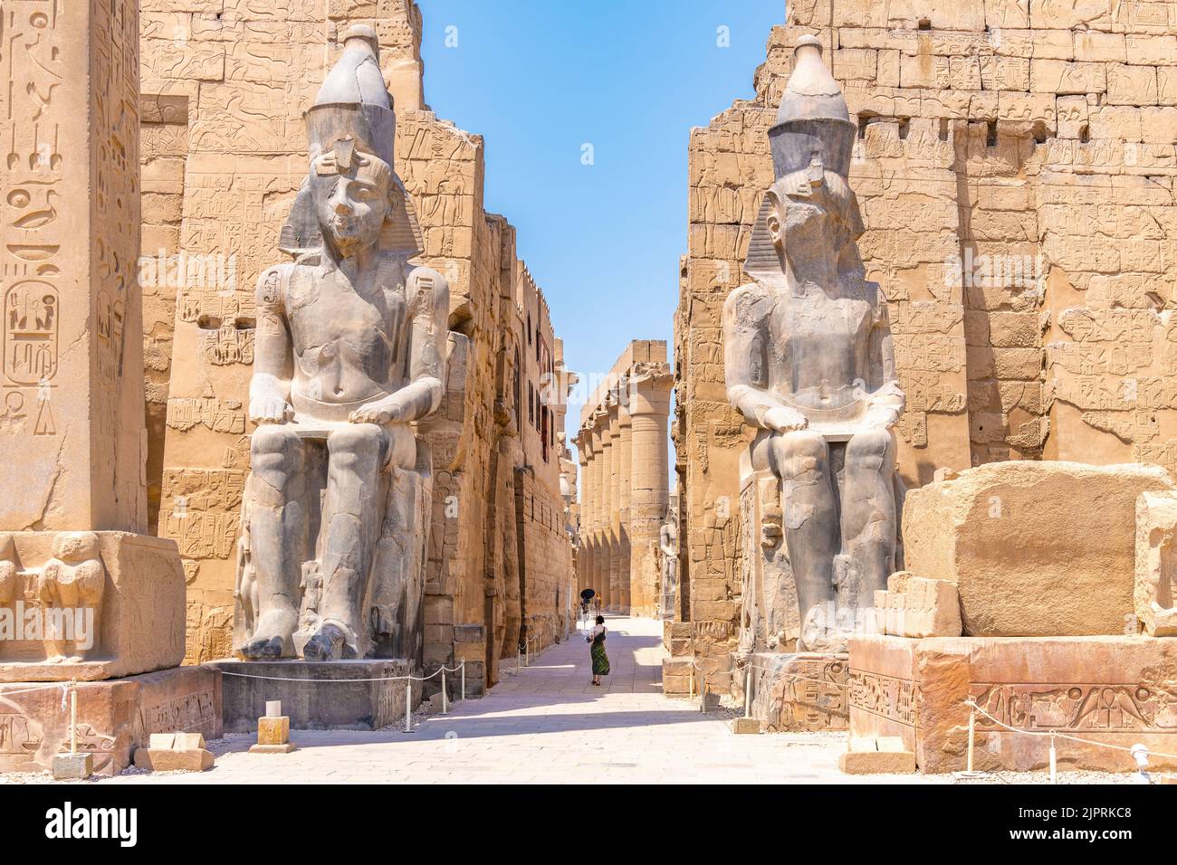 Luxor, Egypt; August 17, 2022 - A vistor entering the entrance  to the Luxor Temple in the middle of Luxor town, Egypt. Stock Photo