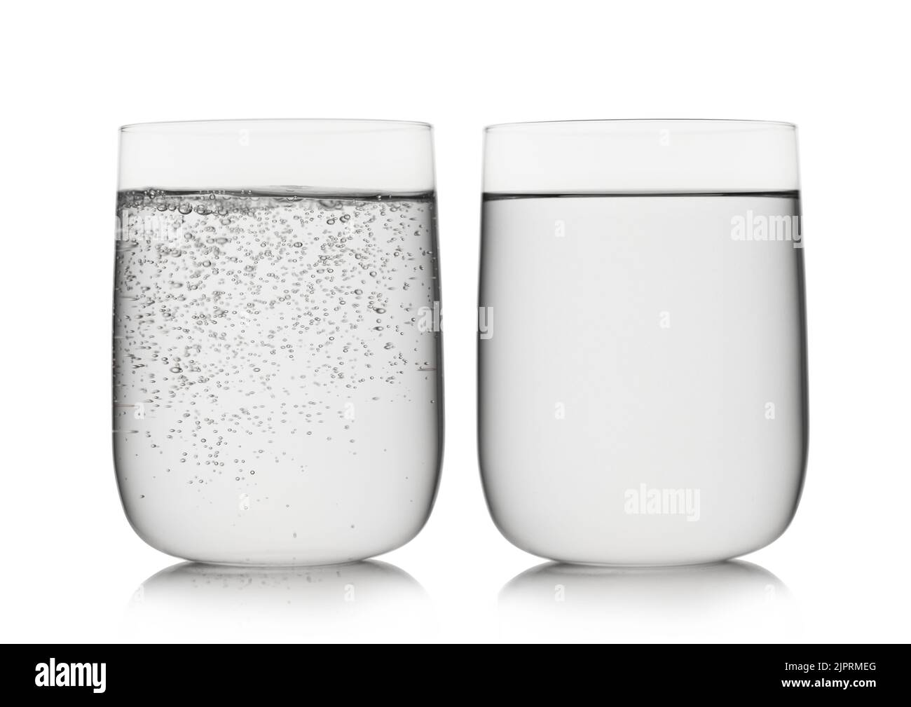Sparkling mineral water and still water in large glass on white. Stock Photo