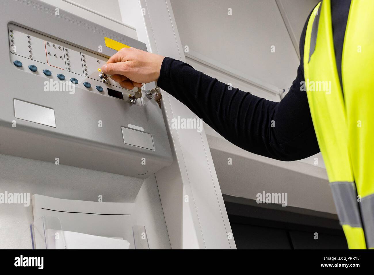 Close-up of electrician Opening Fire Panel In Server Room Stock Photo