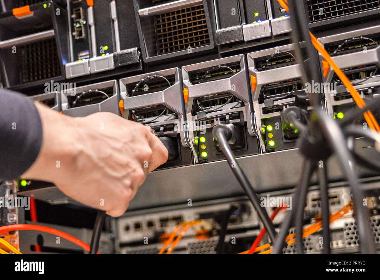 Close-up of Male Technician Plugging Computer Cable In San Stock Photo