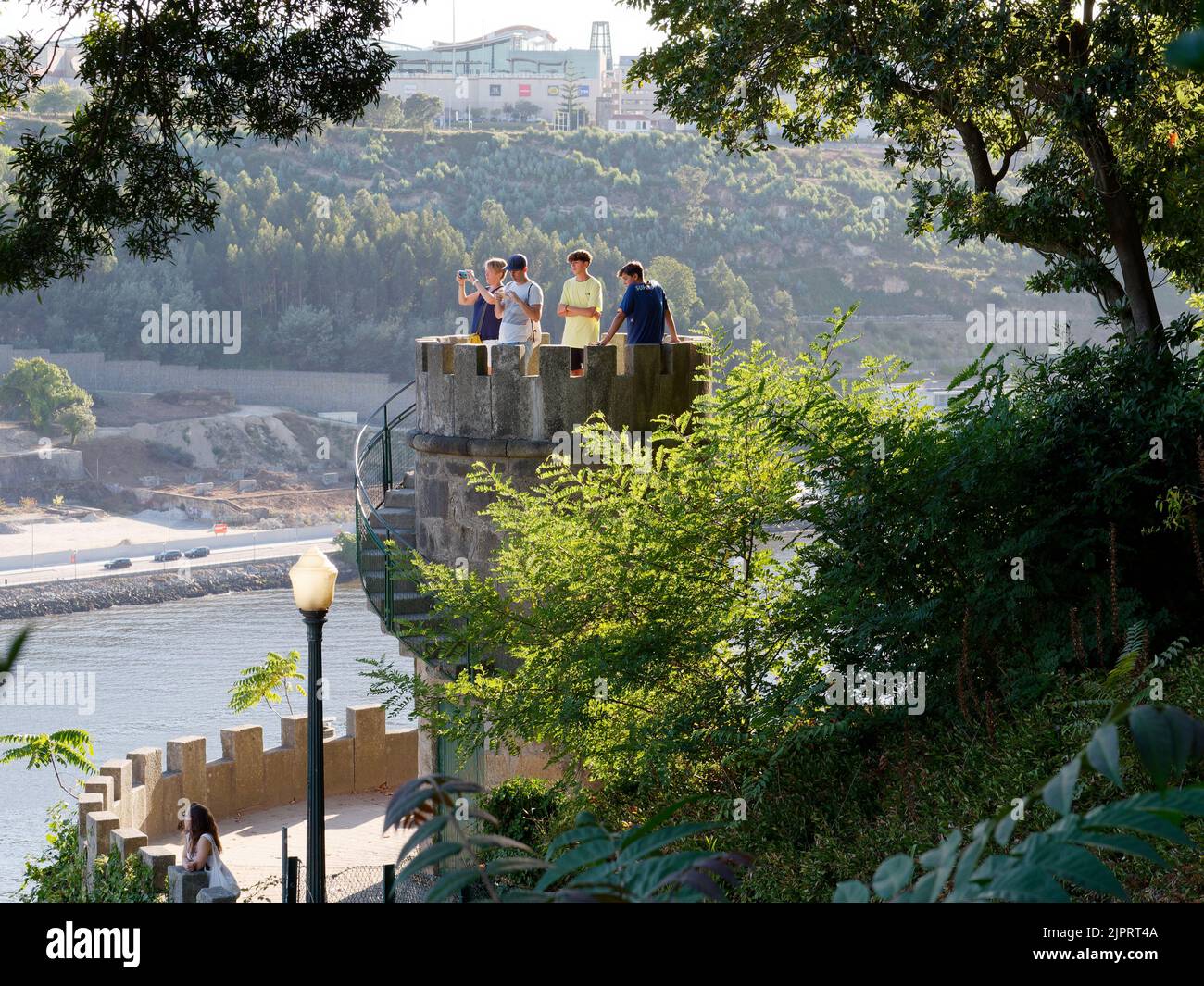 Tourists enjoying the view from a tower in Crystal Palace Gardens (Jardins do Palacio de Cristal) over the Douro River. Porto, Portugal. Stock Photo