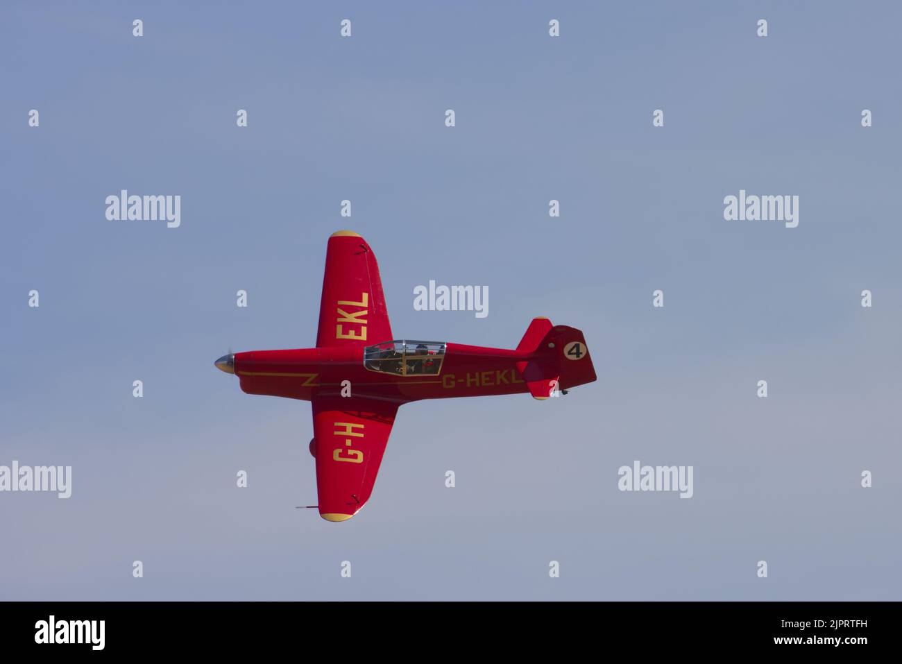 A replica red Percival Mew Gull of the 1930s racing aeroplane in flight. Stock Photo