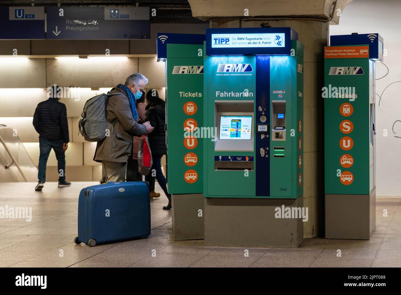 A traveler in front of a ticket machine buying a ticket in an underground train station Stock Photo