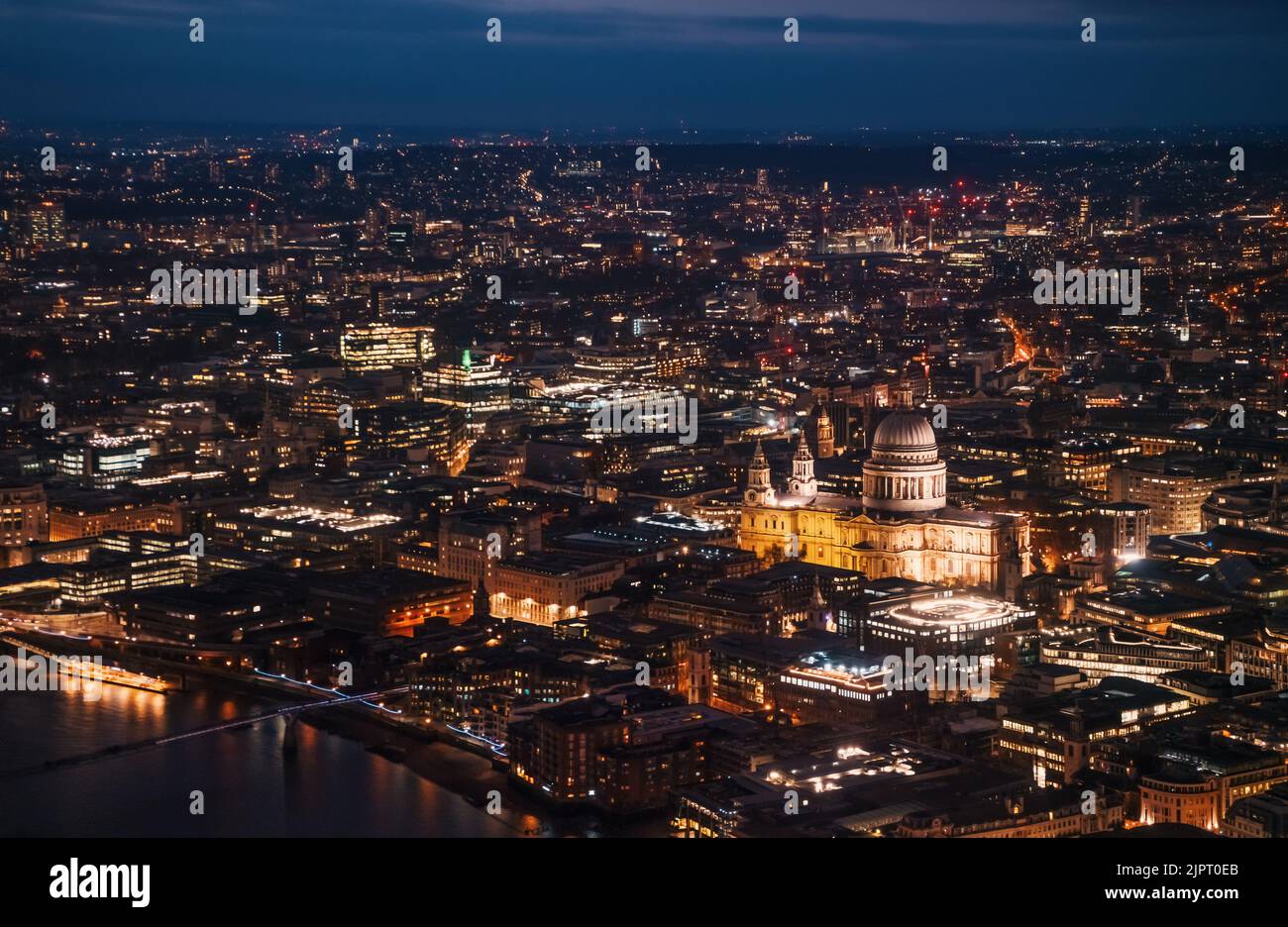 Aerial view of north east part of London, in evening. St Pauls Cathedral visible over river Thames Stock Photo