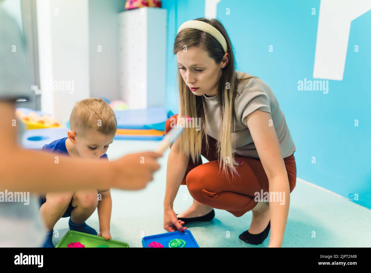 Caucasian teacher making activities with her kids in the kindergarten, preschoolers concept. High quality illustration Stock Photo