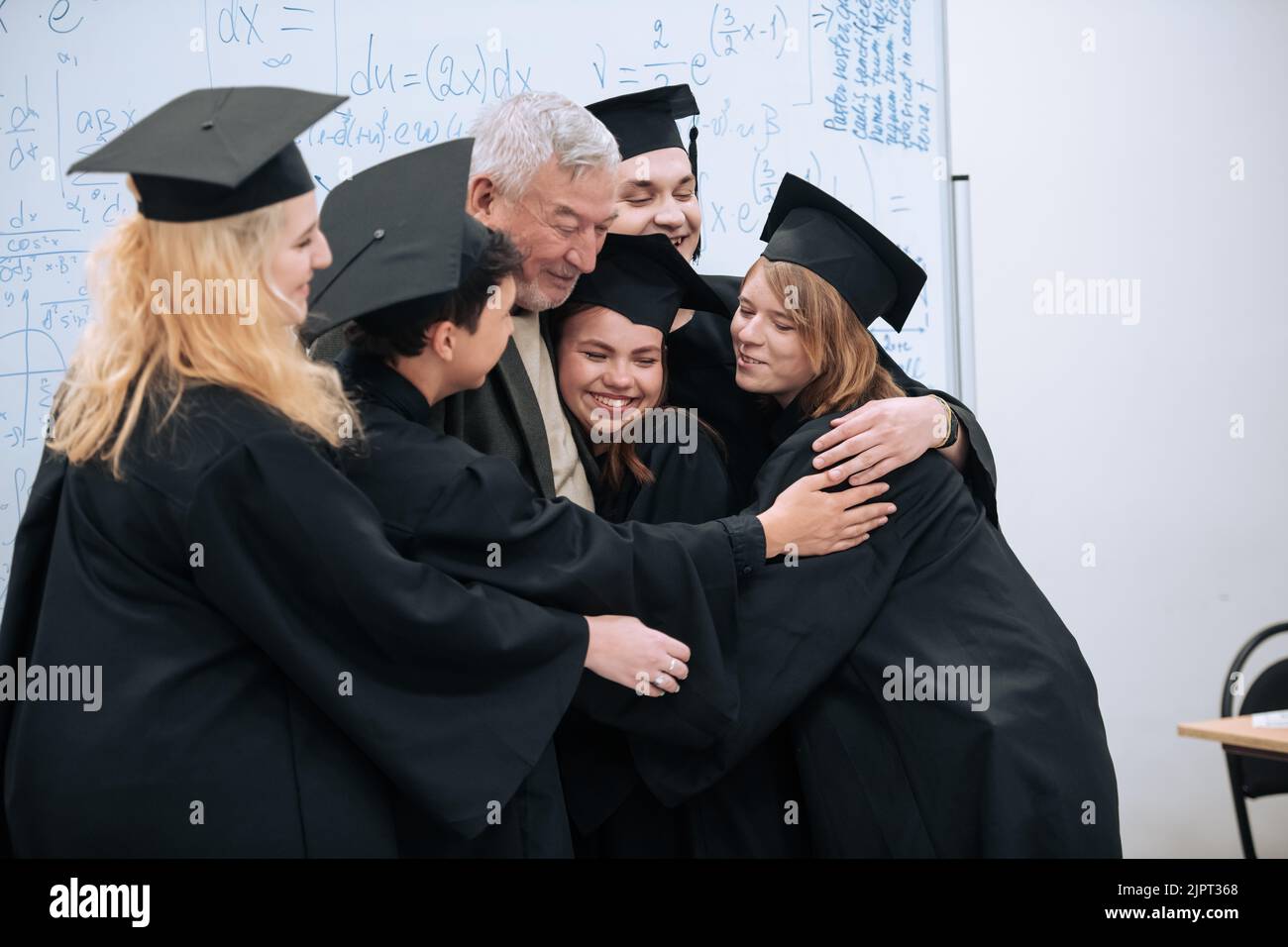 A wise elderly university professor rejoices together with his students ...