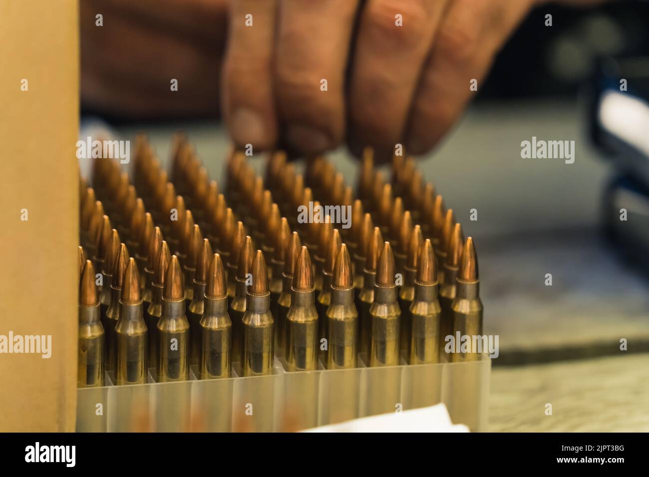 Close up shot of nato bullets stored in plastic box for sale. Selling