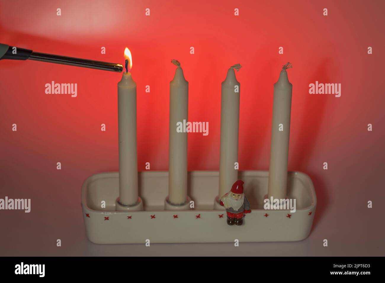Close up view of ignition first red candle in traditional candlesticks