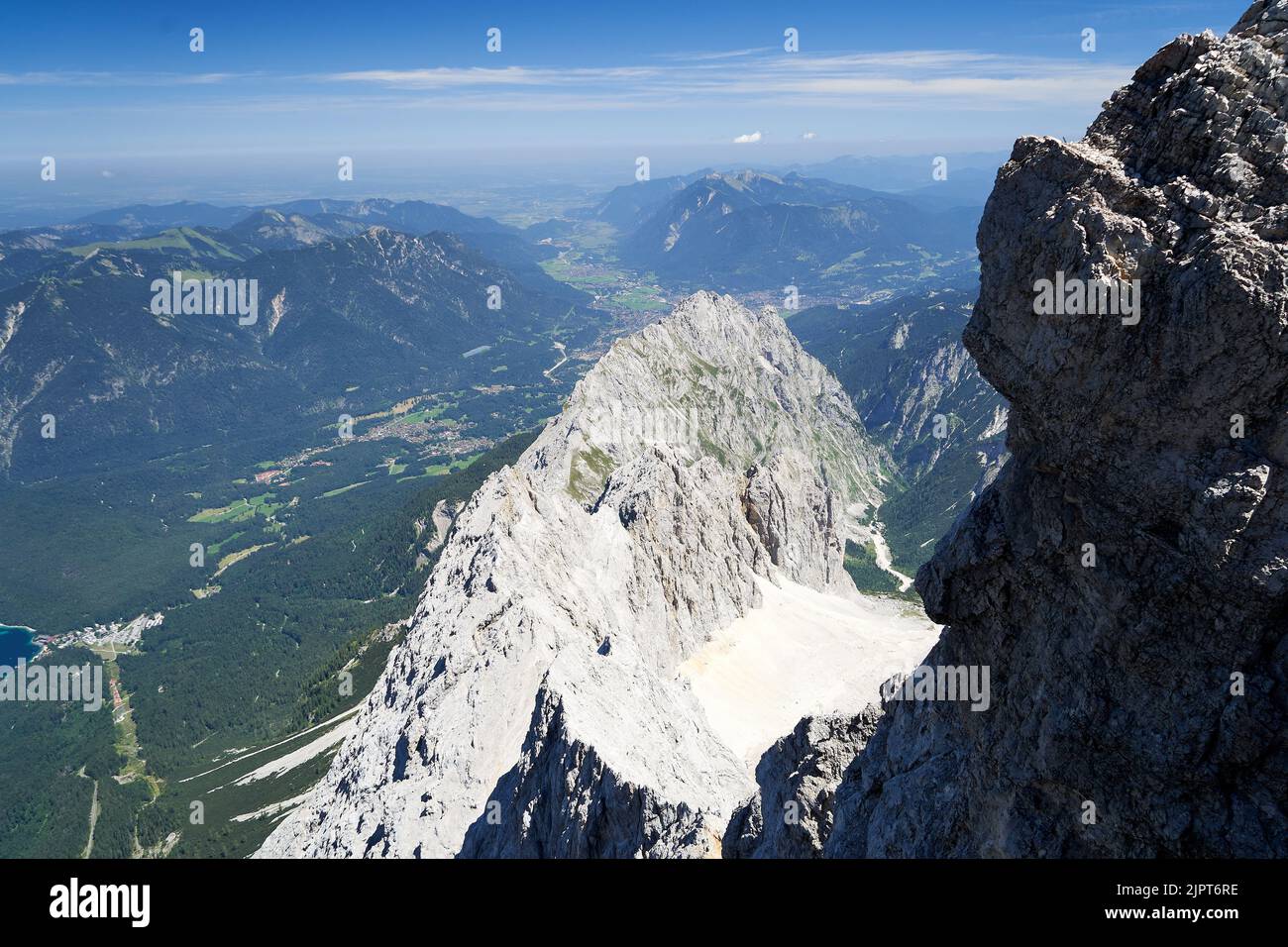 View on the high alp mountains, blue sky with a little clouds. Mountain ridge in the middle. Stock Photo