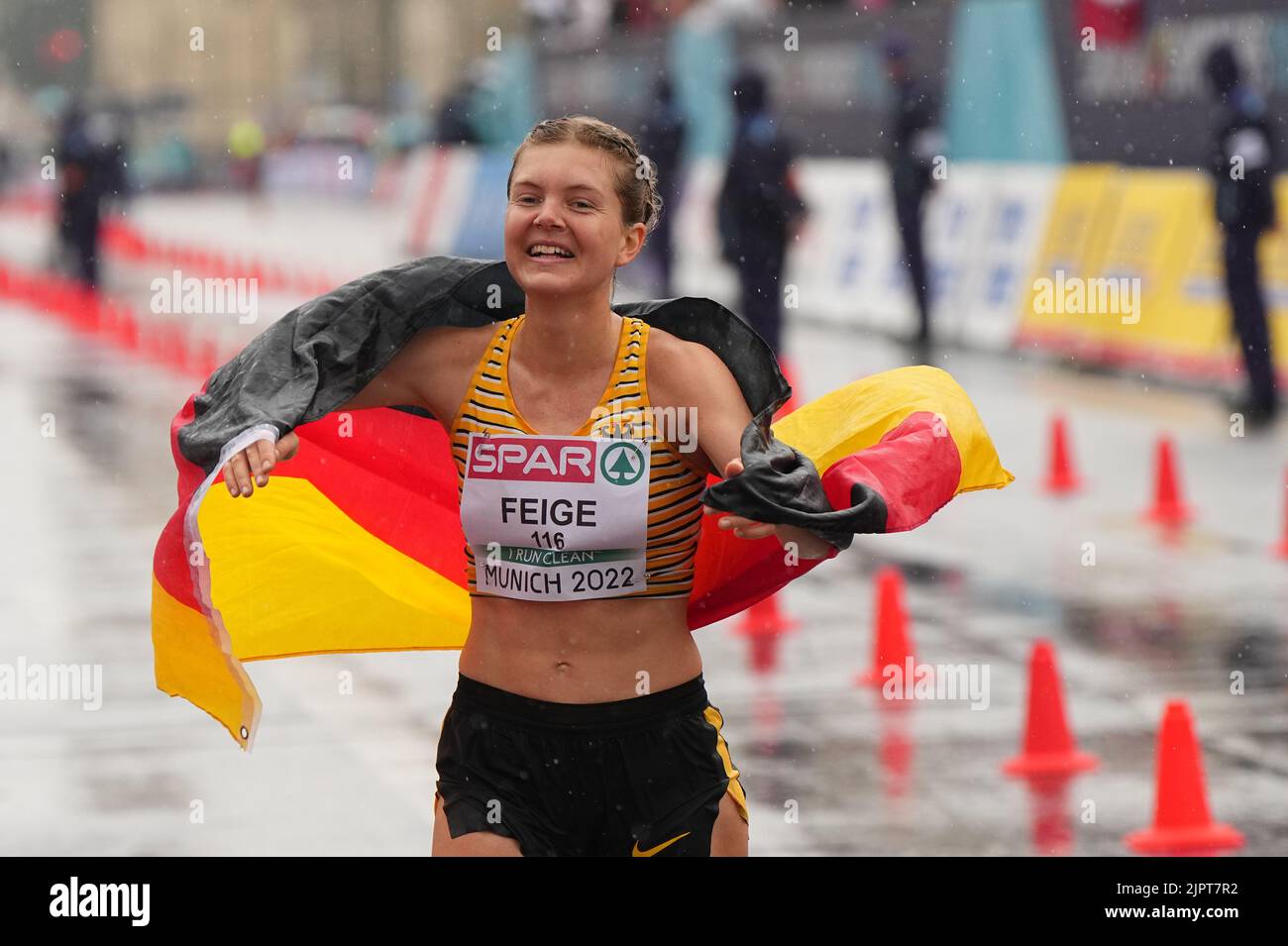 Munich, Germany. 20th Aug, 2022. Athletics: European Championships, 20 kilometers walking, final, women, the walker Saskia Feige (Germany) crosses the finish line in third place and is happy about the bronze medal. Credit: Soeren Stache/dpa/Alamy Live News Stock Photo