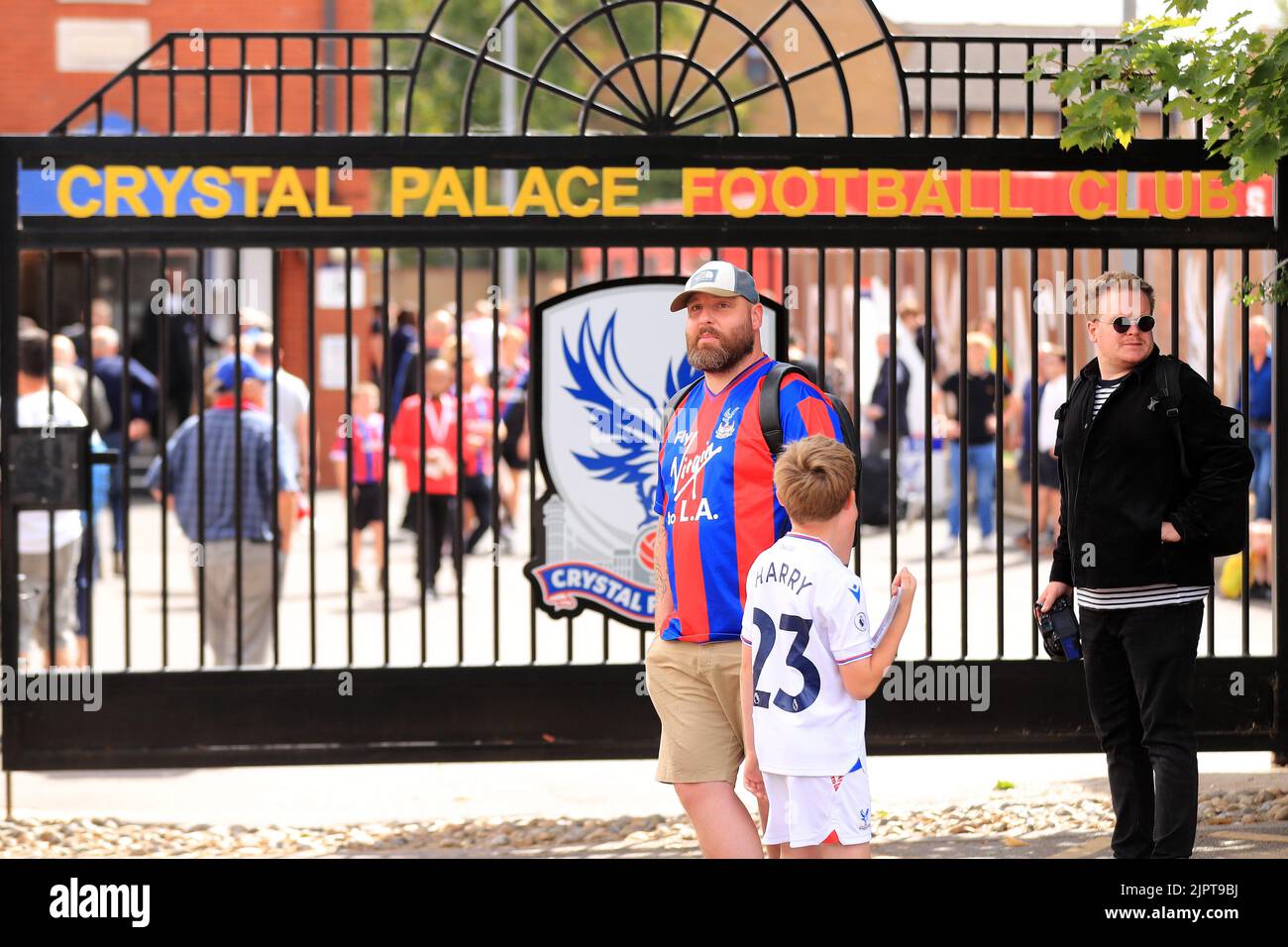 A Crystal Palace fan and his son stand in front of the club gates prior ...