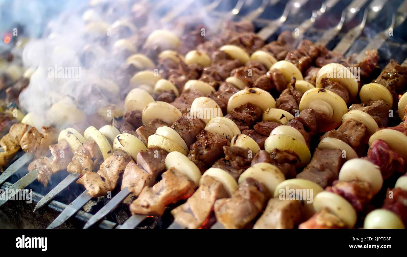 shish kebab from pork, on skewers, fried on coals. close up. Grill on