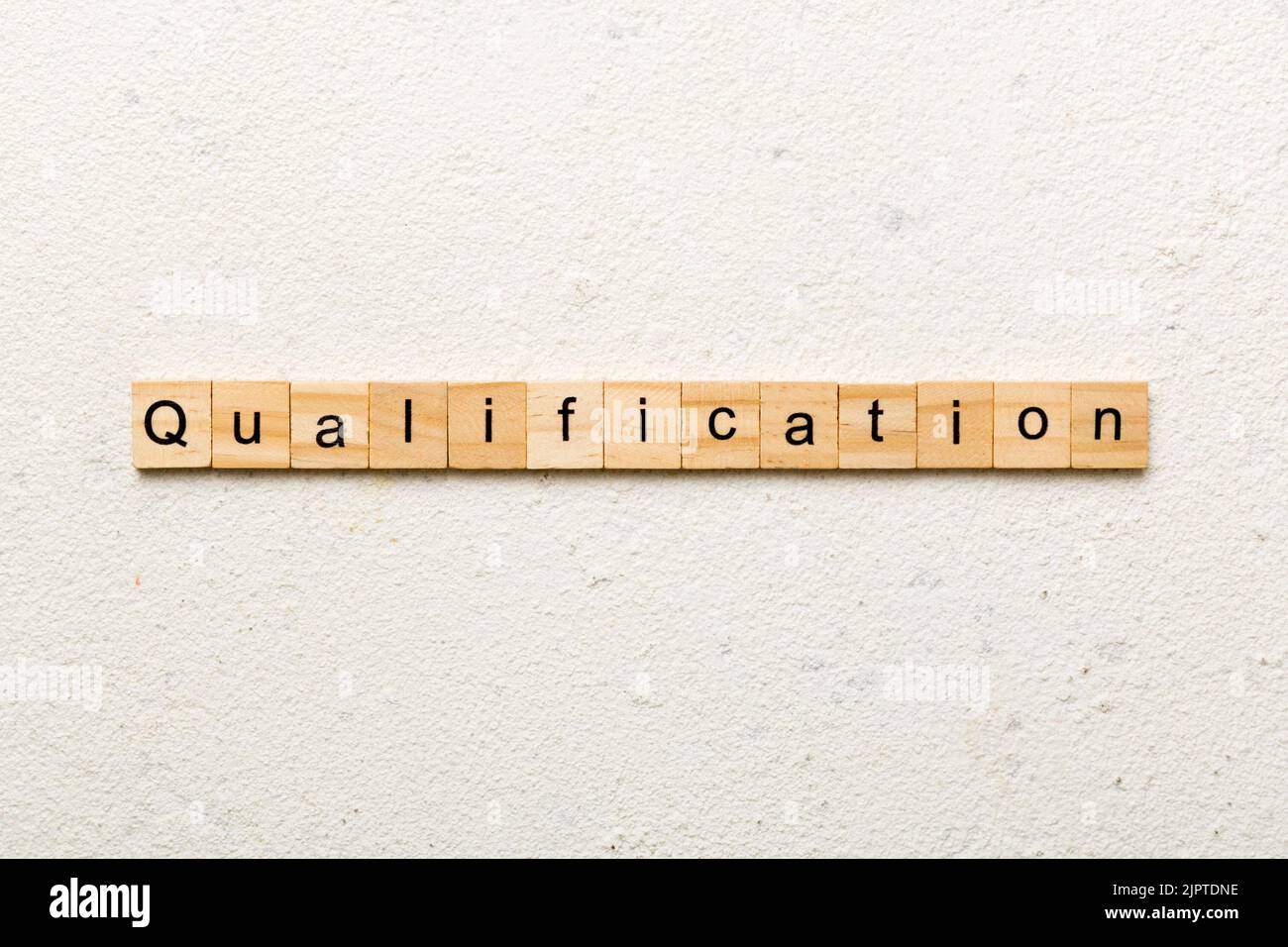 qualification word written on wood block. qualification text on table