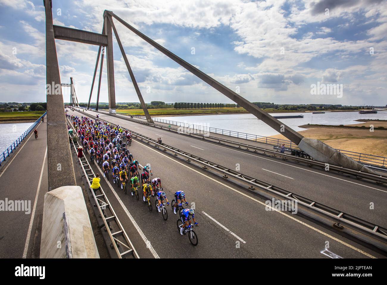 OOIJ - Atmospheric image of the peloton that passes the Waal over the Prince Willem Alexander Bridge near Ooij during the second stage of the Tour of Spain (Vuelta a Espana). The second stage of the Vuelta goes from Den Bosch to Utrecht. ANP VINCENT JANNINK Stock Photo