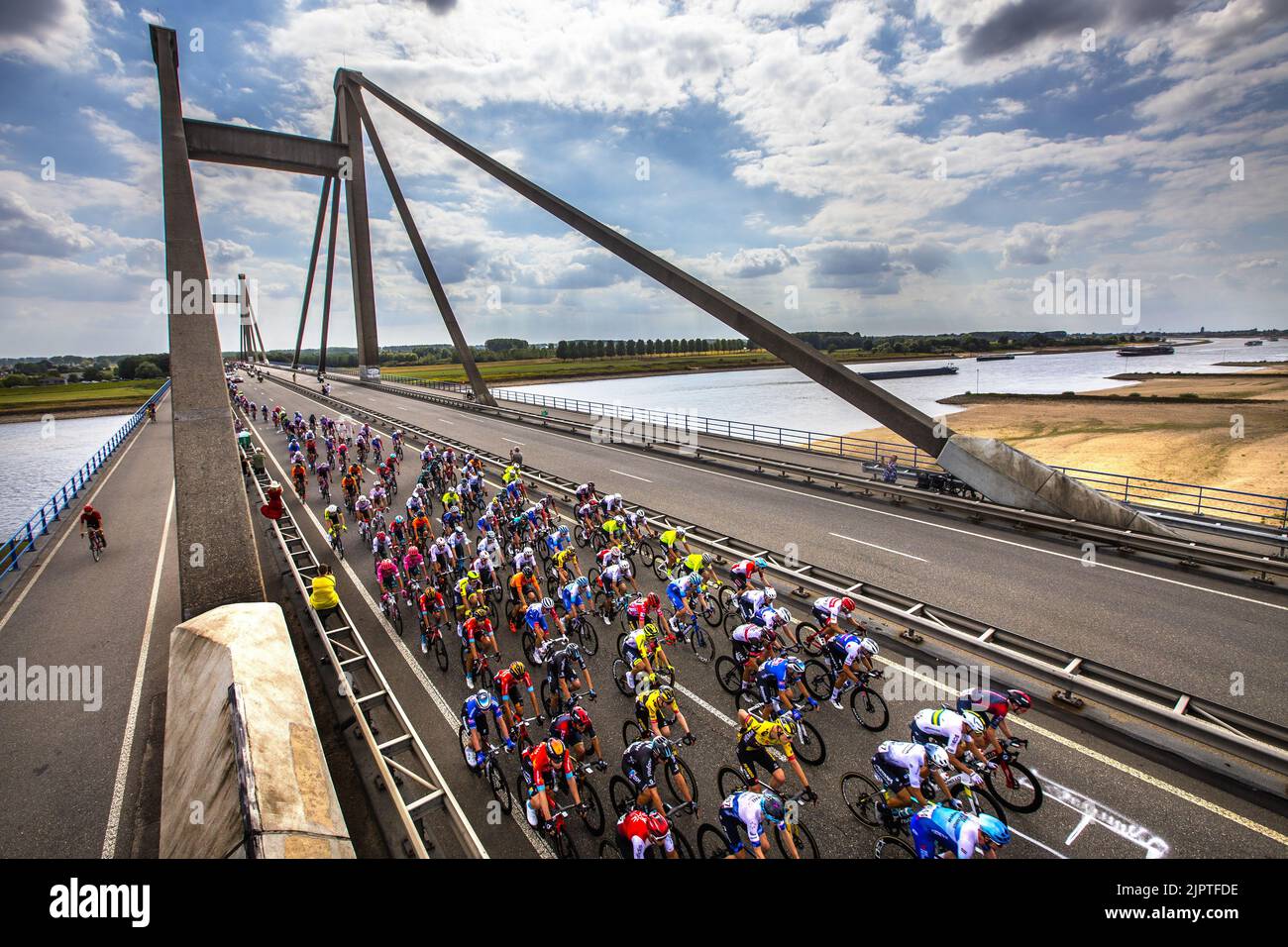 OOIJ - Atmospheric image of the peloton that passes the Waal over the Prince Willem Alexander Bridge near Ooij during the second stage of the Tour of Spain (Vuelta a Espana). The second stage of the Vuelta goes from Den Bosch to Utrecht. ANP VINCENT JANNINK Stock Photo