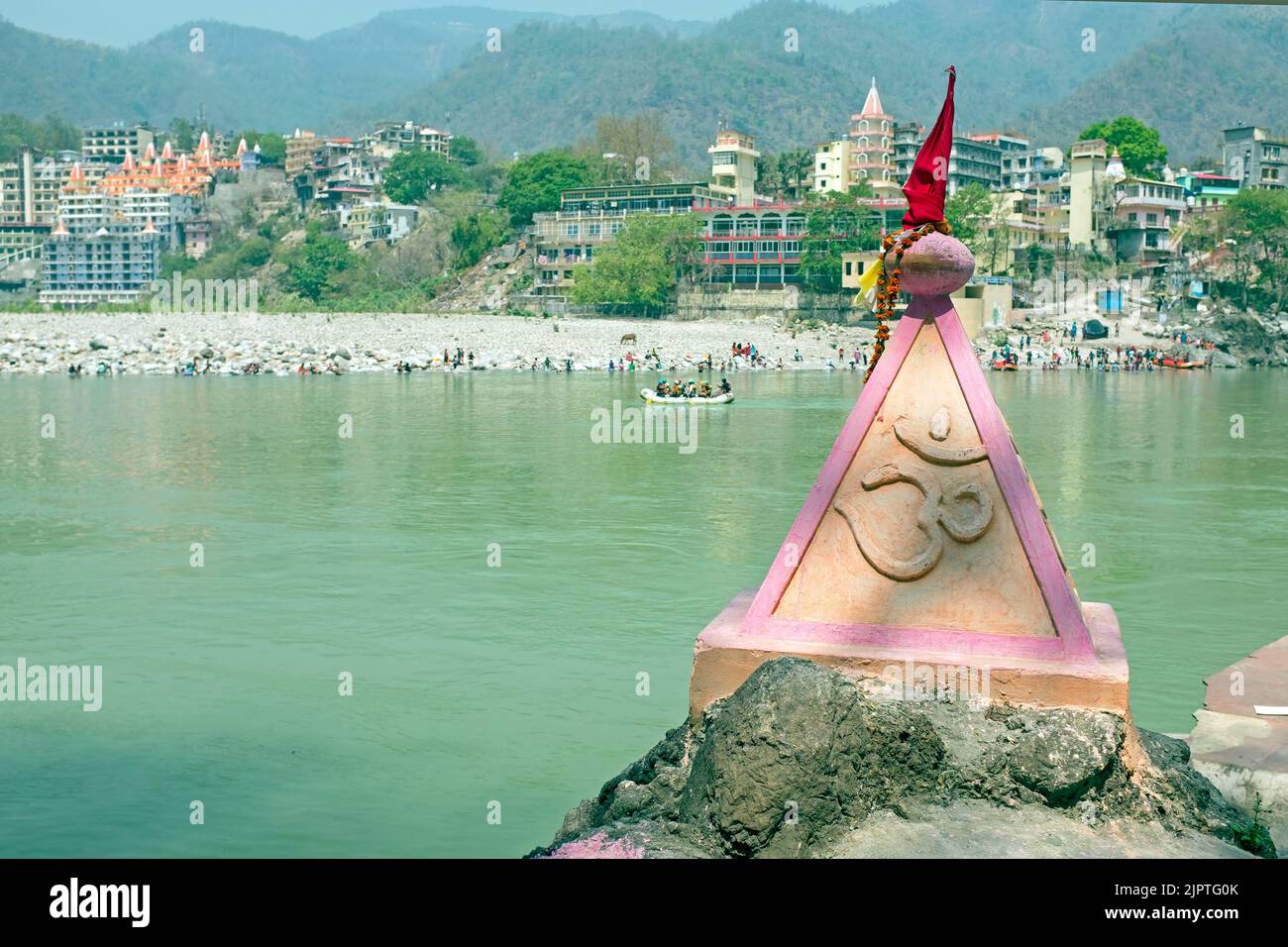 Ohm sign on a rock at the holy river Ganga near Rishikesh in India Asia Stock Photo