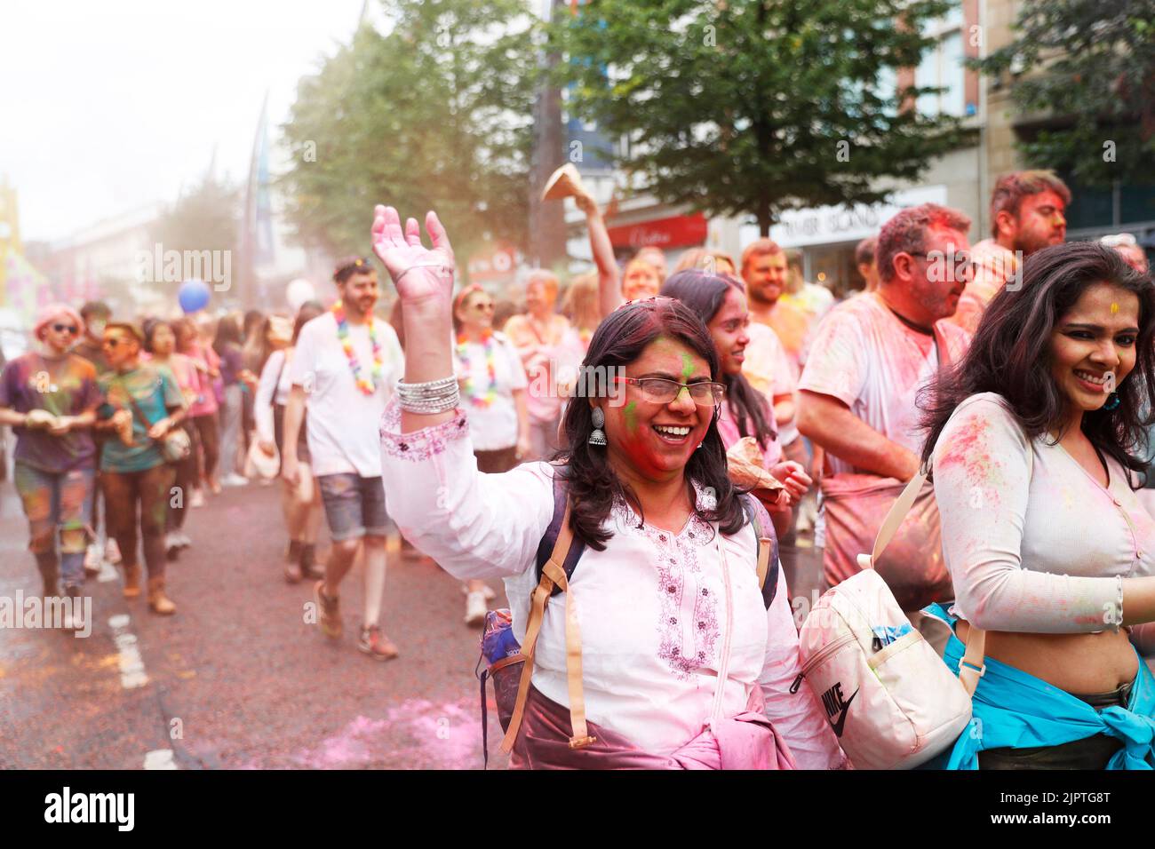 People enjoy the atmosphere as the Mela Carnival parades through