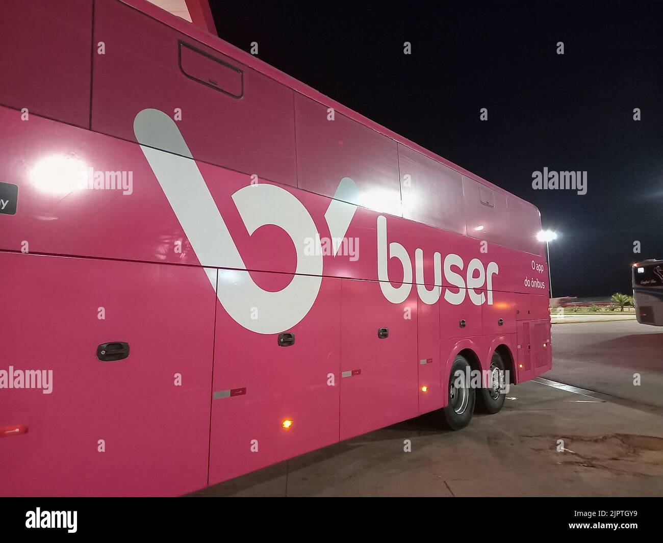 Sao Sebastiao da Bela Vista, Minas Gerais, Brazil - August 15, 2022: detail of a Buser app bus at a stopping point at night Stock Photo