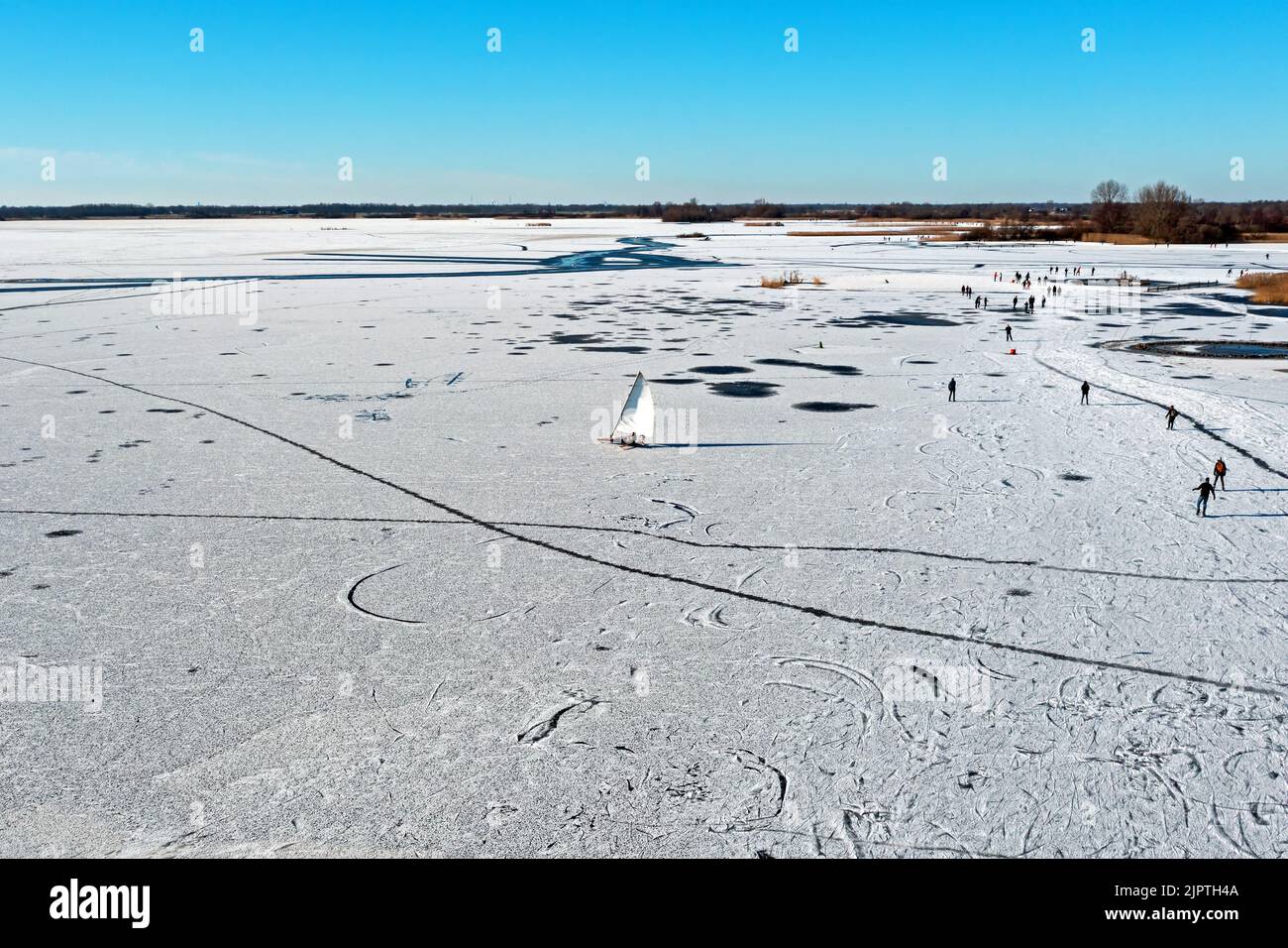 Aerial from ice sailing and skating on Bergumer lake in winter in Friesland the Netherlands Stock Photo