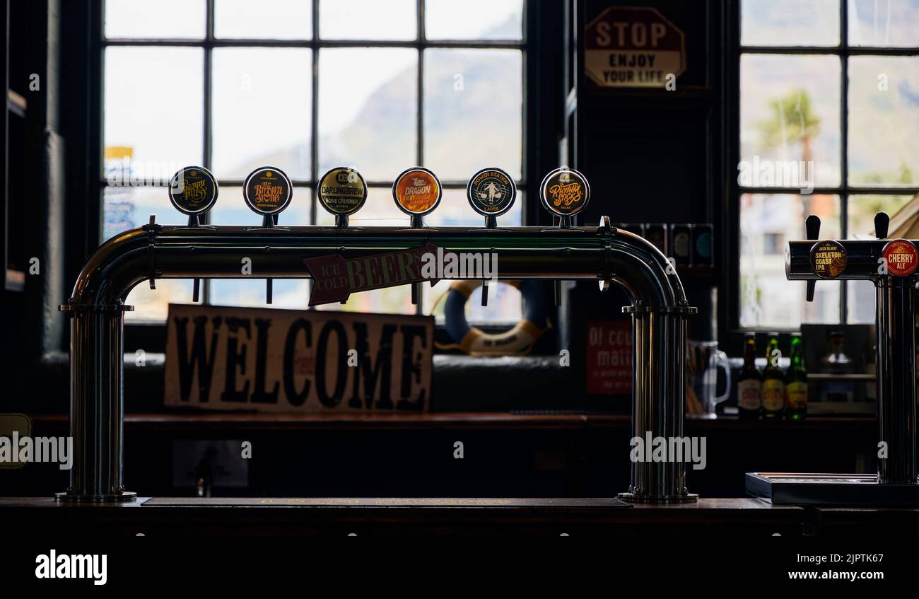 A closeup of bar beer dispenser, beer on tap at V&A waterfront in Cape