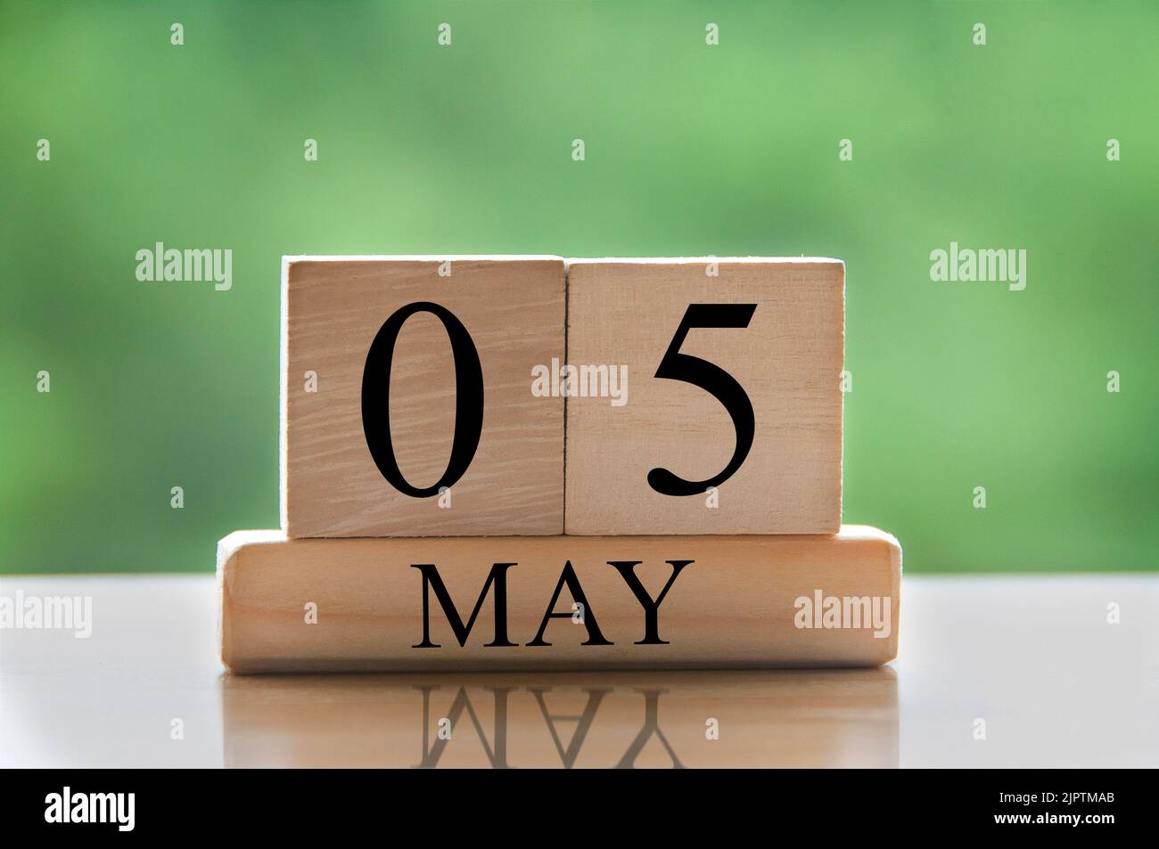 May 5 calendar date text on wooden blocks with blurred nature background.  Copy space and calendar concept Stock Photo - Alamy