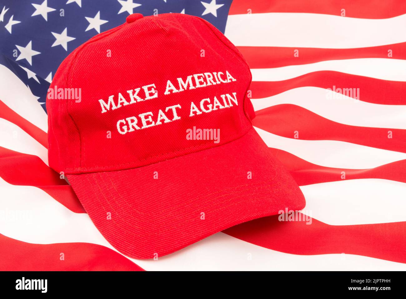 Red Donald Trump MAGA cap and U.S Stars & Stripes flag.For Maga hats, Trump supporters, Trump presidency 2024, US elections, Trump America first Stock Photo