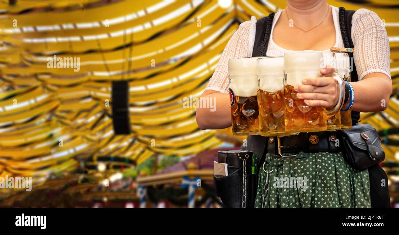 Oktoberfest, Munich. Waiter in traditional Bavarian costume serving