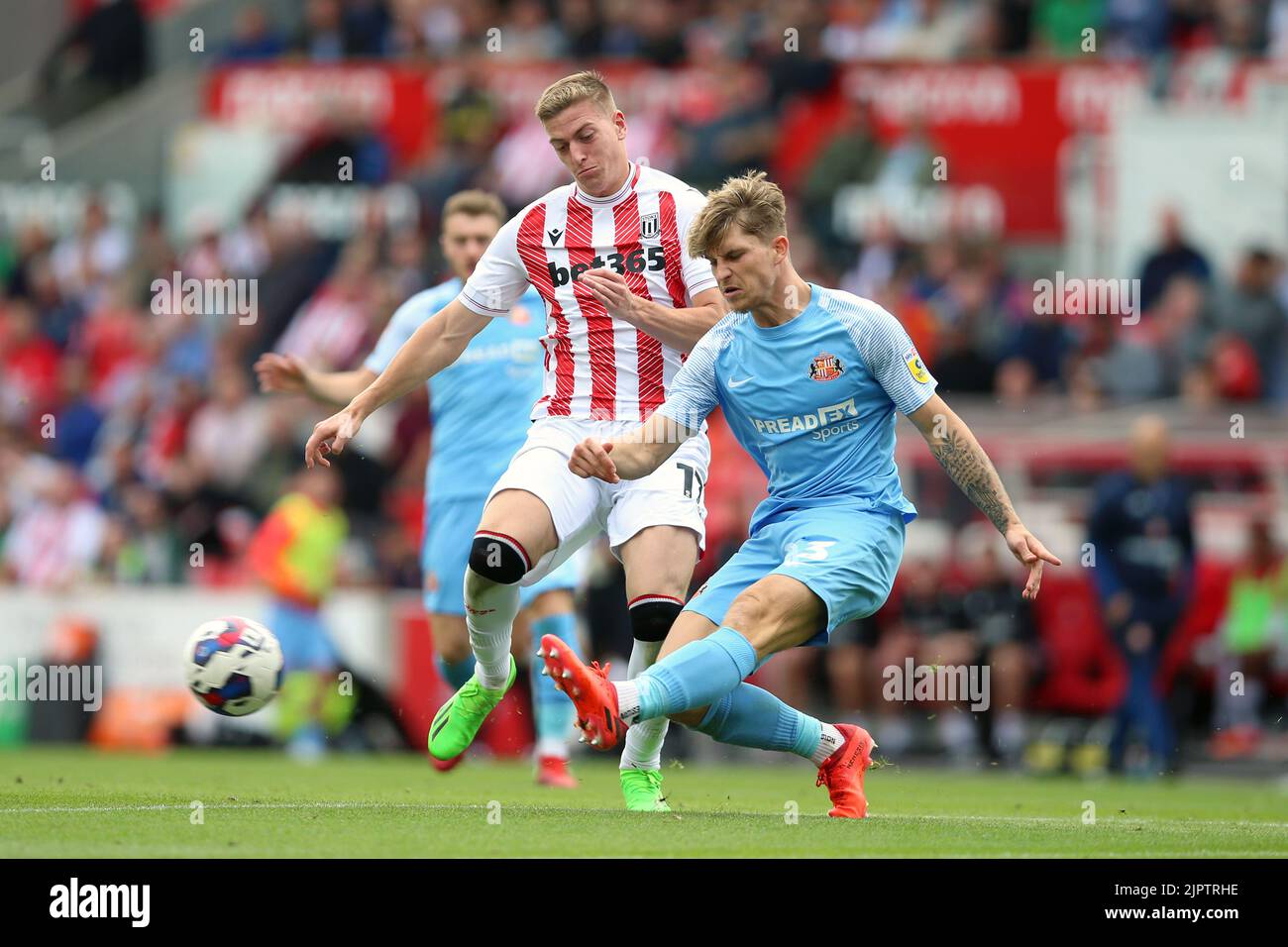 Stoke City's Liam Delap and Sunderland's Dennis Cirkin (right) battle