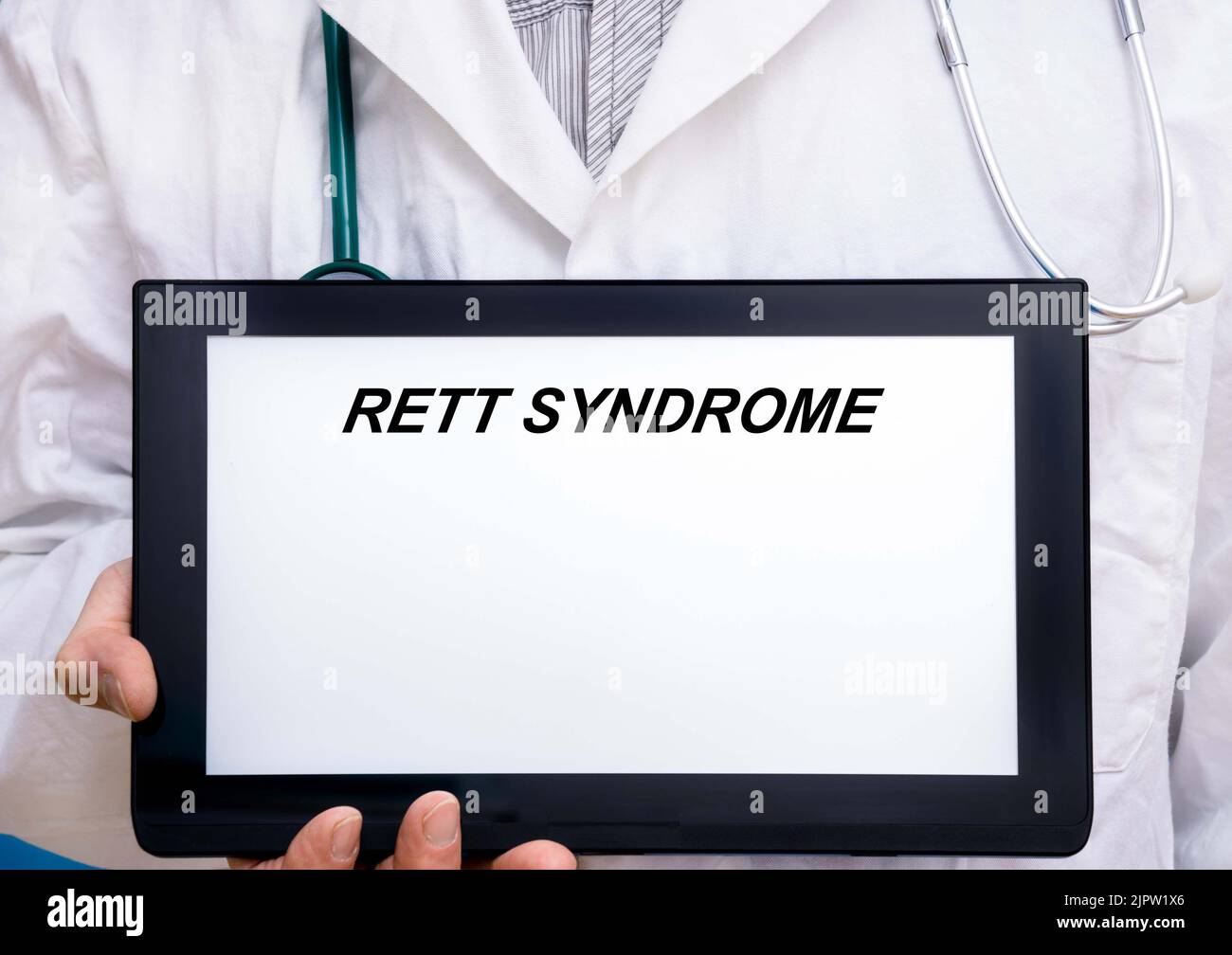 Rett Syndrome.  Doctor with rare or orphan disease text on tablet screen Rett Syndrome Stock Photo