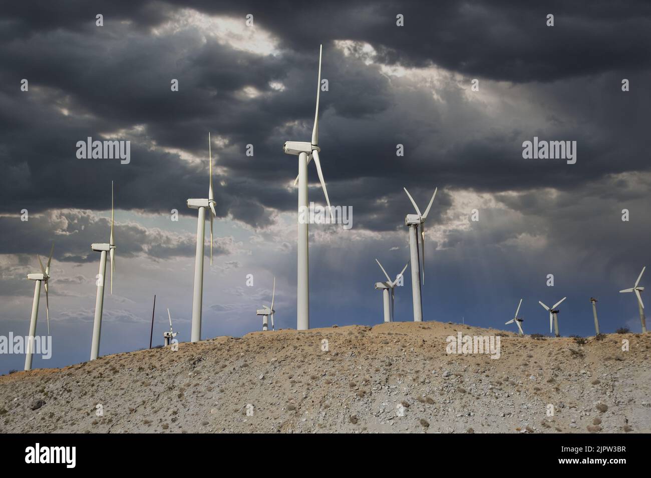 A hill with wind turbines under the cloudy sky Stock Photo - Alamy