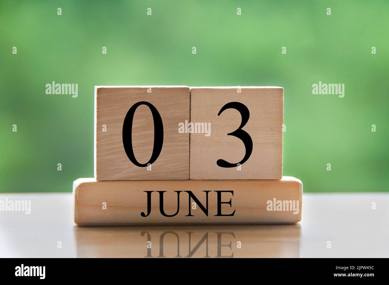 June 3 calendar date text on wooden blocks with blurred nature background. Copy space and calendar concept. Stock Photo