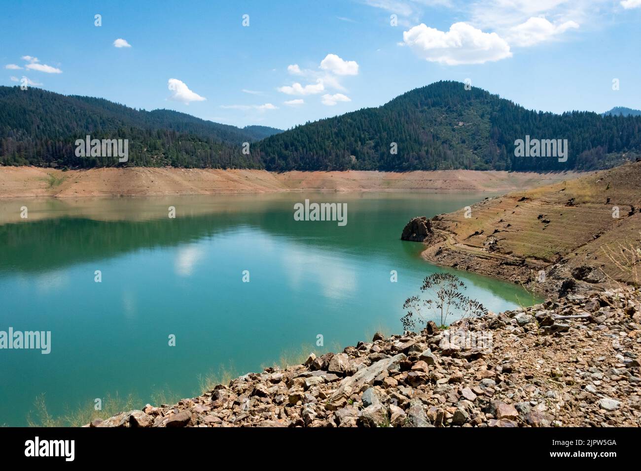 Abandoned Trinity Lake reservoir with 25% water during extreme drought in California, absence of fishermen, boats or houseboats in August 2022. Stock Photo