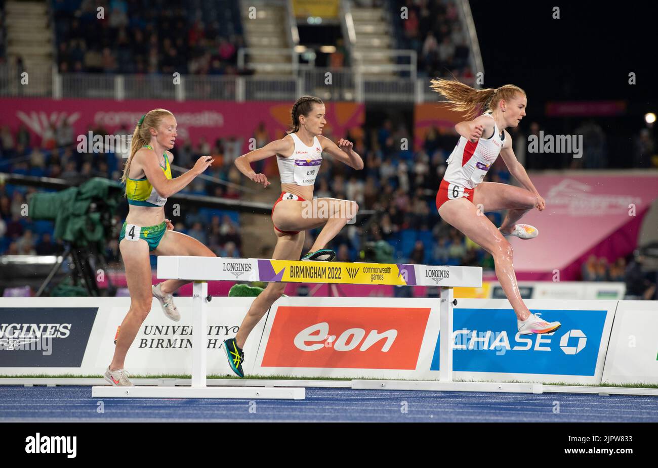 Amy Cashin of Australia and Lizzie Bird and Aimee Pratt of England competing in the women’s 3000m steeplechase final at the Commonwealth Games at Alex Stock Photo