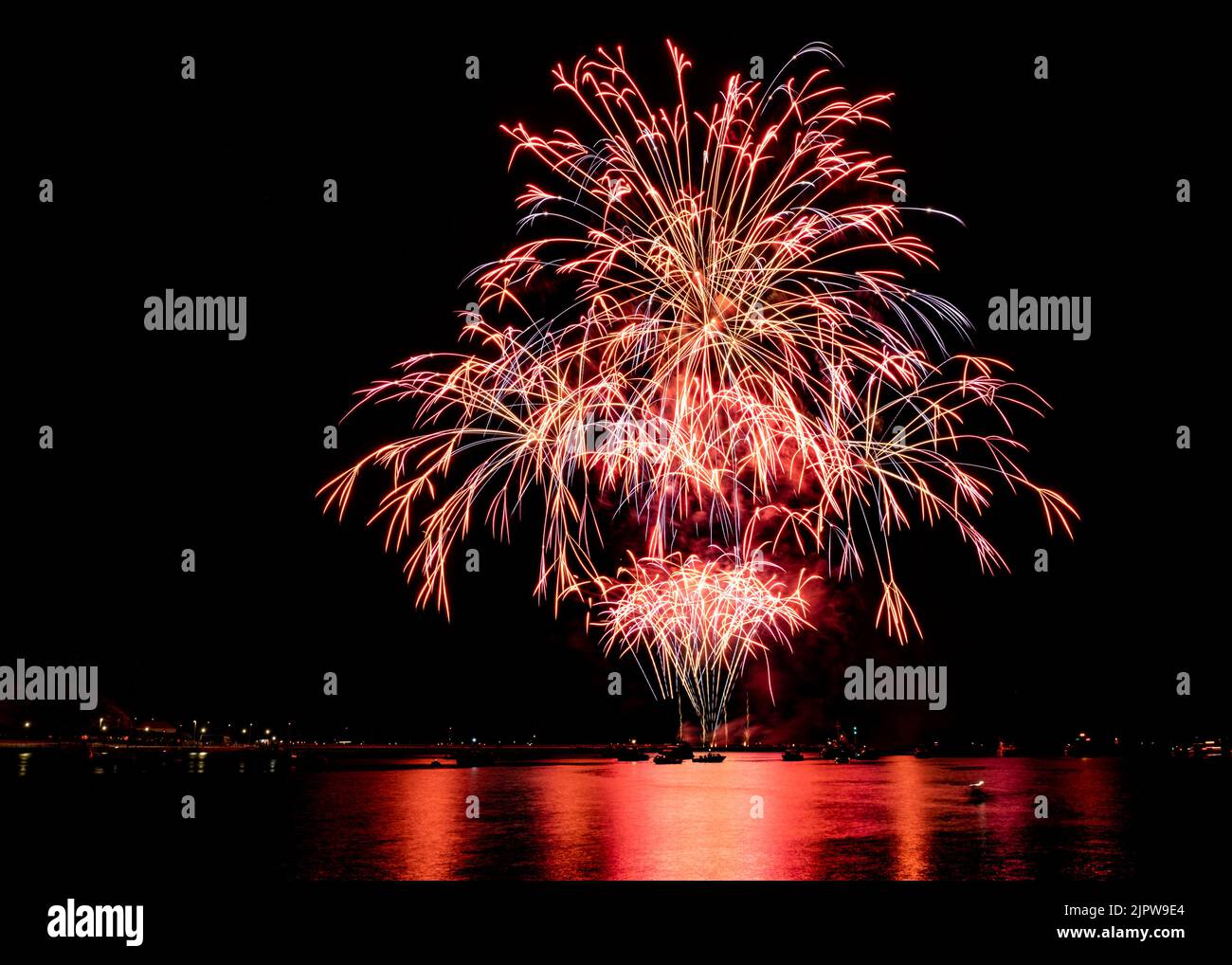 Firework explosions over the harbour from The Queen Annes Battery as part of 2022 British Firework Championships held at Plymouth, Devon.  Display by Stock Photo