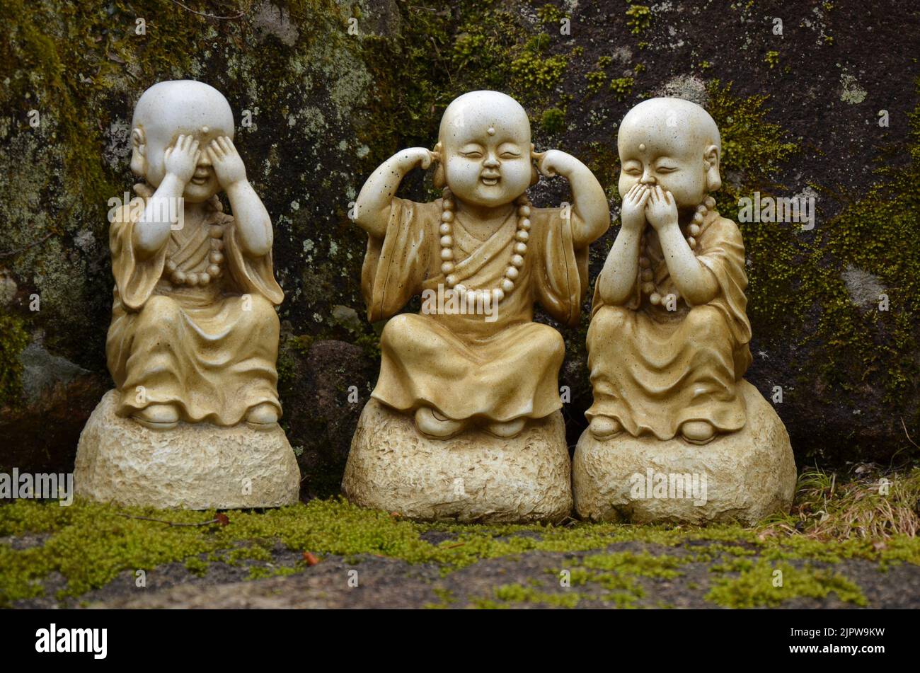 Cute buddhist statues called: 'See no evil, hear no evil, speak no evil' in japanese temple Daisho in, Miyajima. Stock Photo