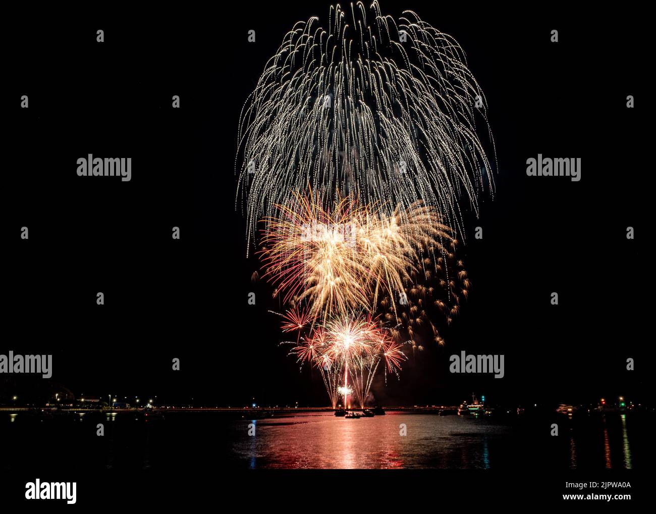 Firework explosions over the harbour from The Queen Annes Battery as part of 2022 British Firework Championships held at Plymouth, Devon.  Display by Stock Photo