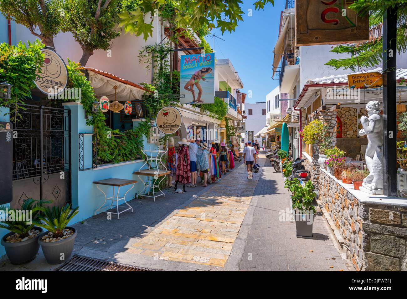 View Of Shops And Cafes In Main Street In Skiathos Town Skiathos view-of-shops-and-cafes-in-main-street-in-skiathos-town-skiathos
