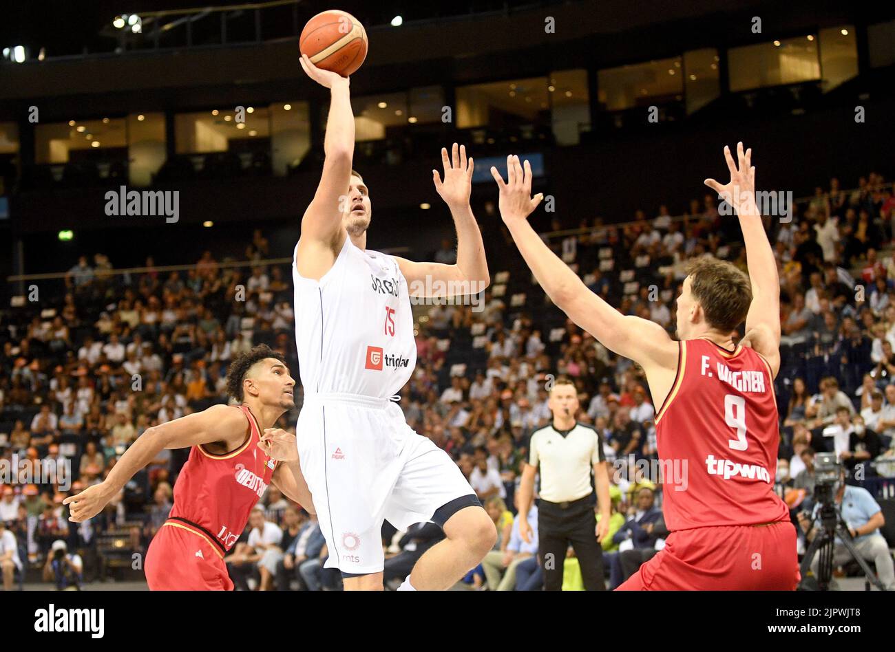 Hamburg, Germany. 20th Aug, 2022. Basketball: Supercup, Germany - Serbia, Final, Barclays-Arena. Serbia's Nikola Jokic (M) scores in front of Germany's Franz Wagner. Credit: Michael Schwartz/dpa/Alamy Live News Stock Photo