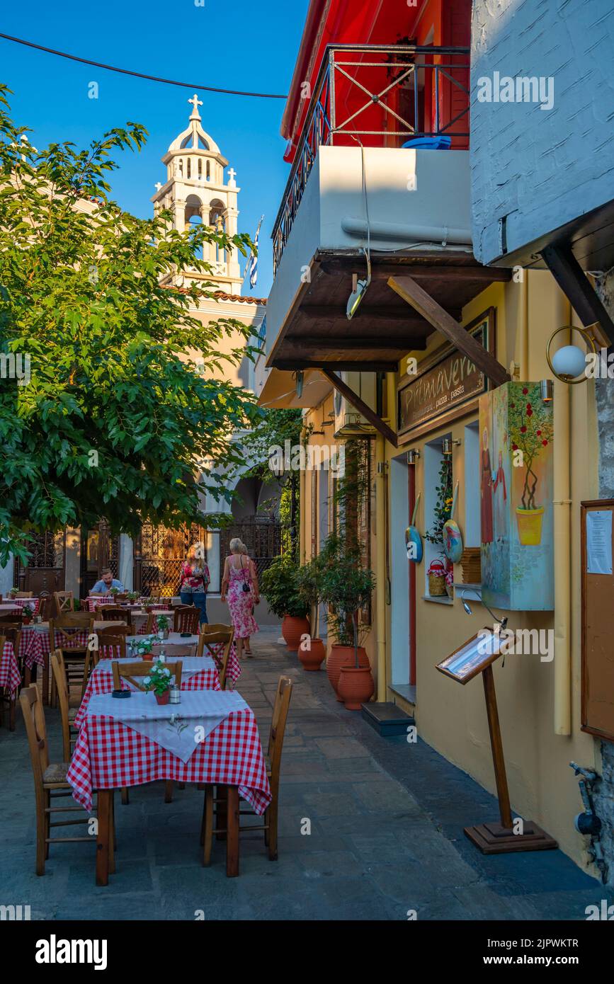 View of restaurant tables in narrow street, Skiathos Town, Skiathos Island, Sporades Islands, Greek Islands, Greece, Europe Stock Photo