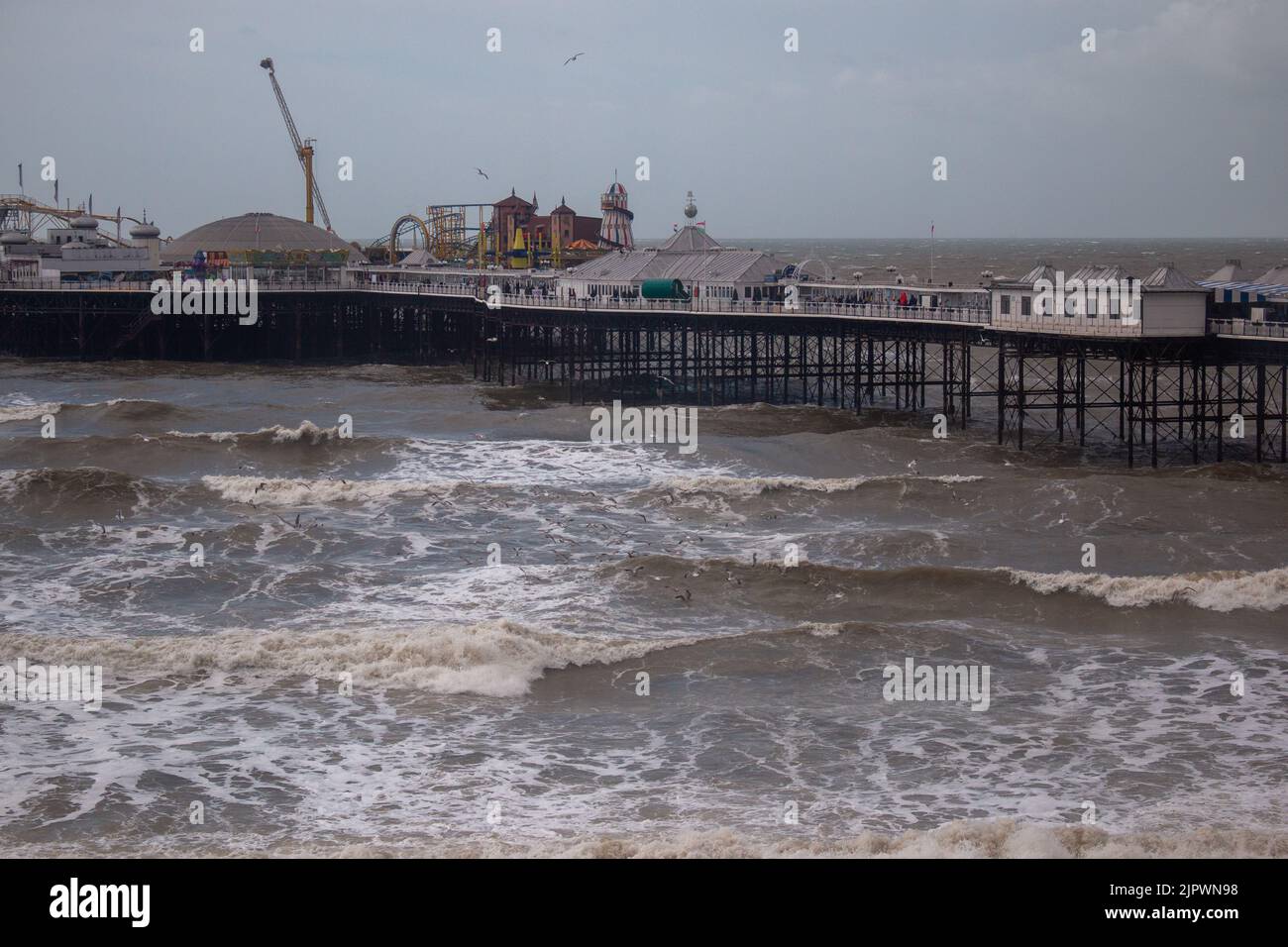 Brighton, Great Britain, March 27th 2016. Brighton Palace Pier on a stormy day in high waves. Stock Photo