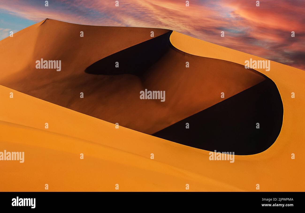 Deep hole in the Wahiba sands during sunset Stock Photo